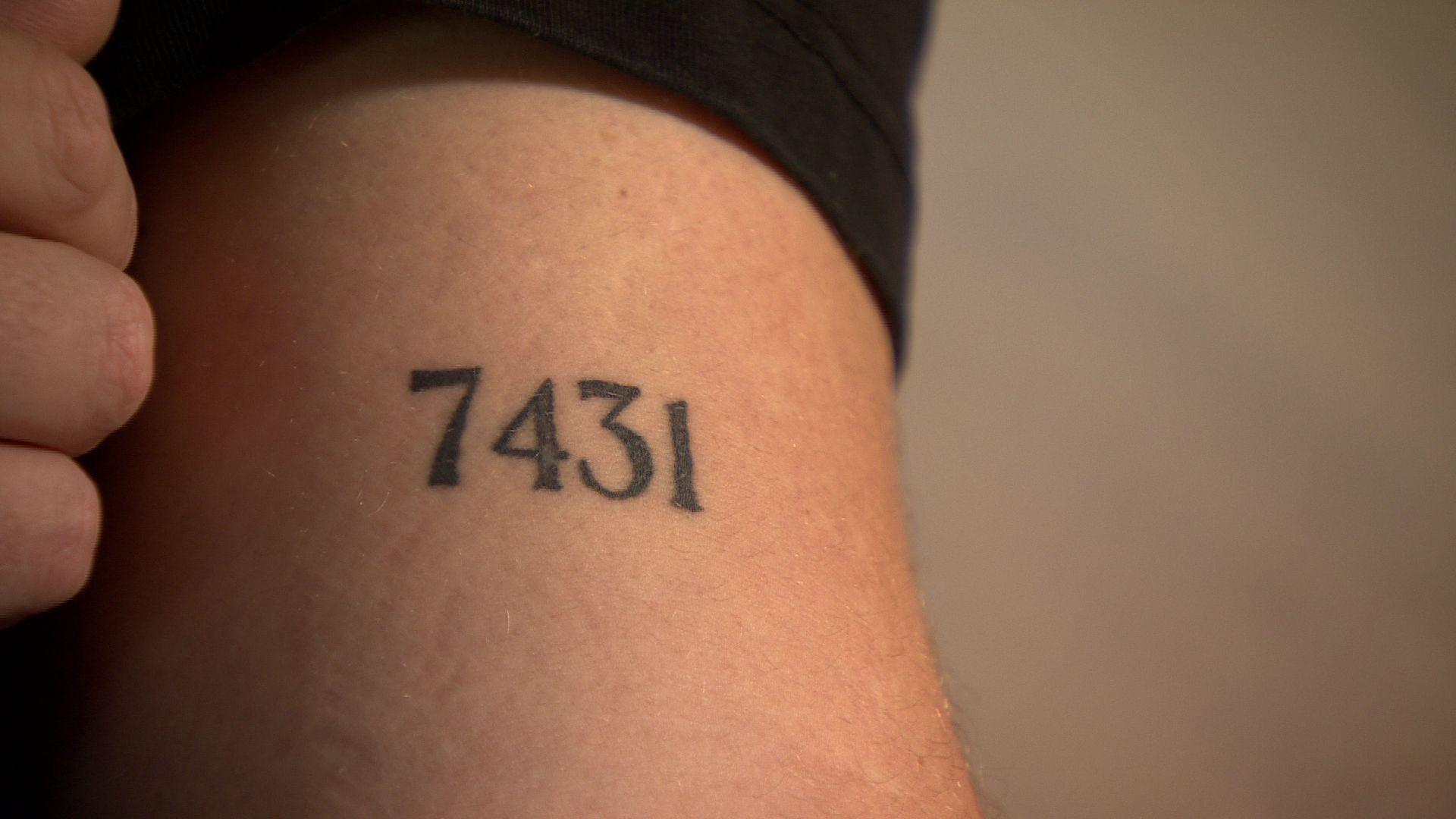 A tattoo that shows the number seven four three one, it is on an arm