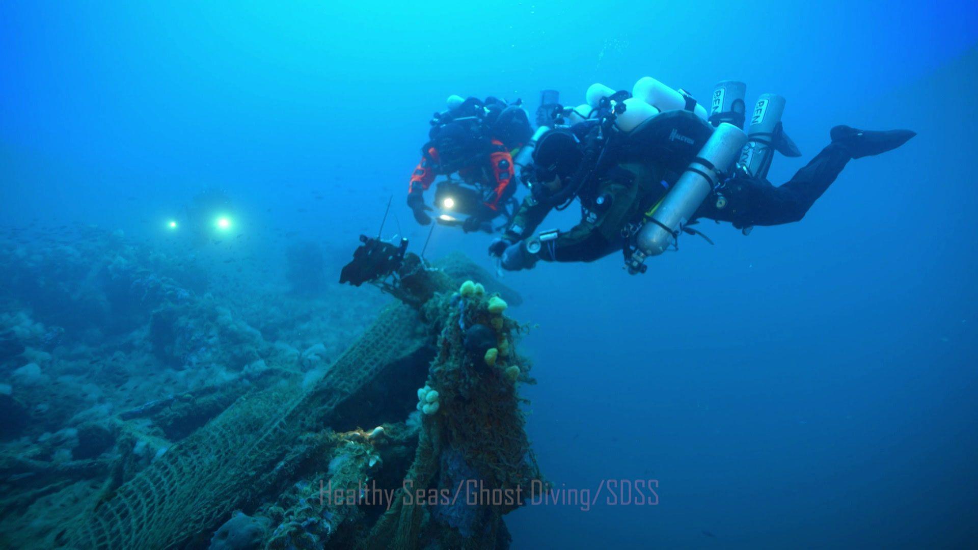 Divers trying to remove abandoned fishing nets from shipwreck 