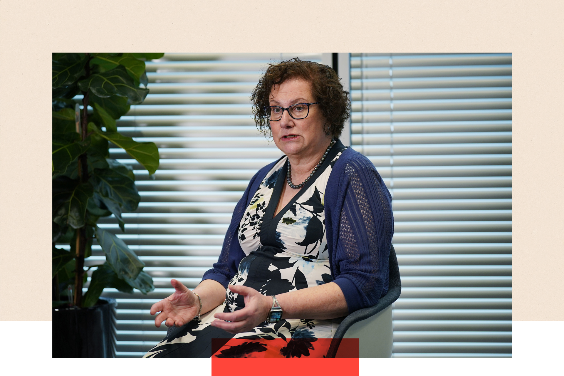 Dr Hilary Cass sitting on a chair, gesturing with her arms