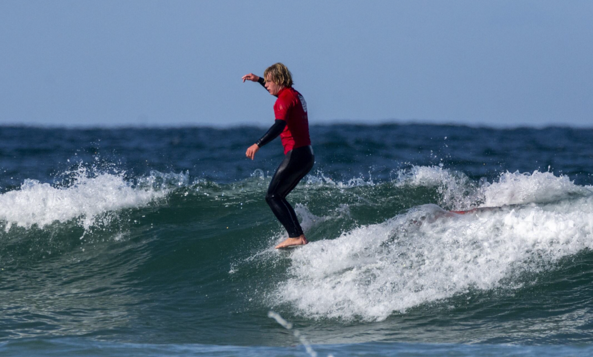 Arthur Randall on a surfboard in the sea