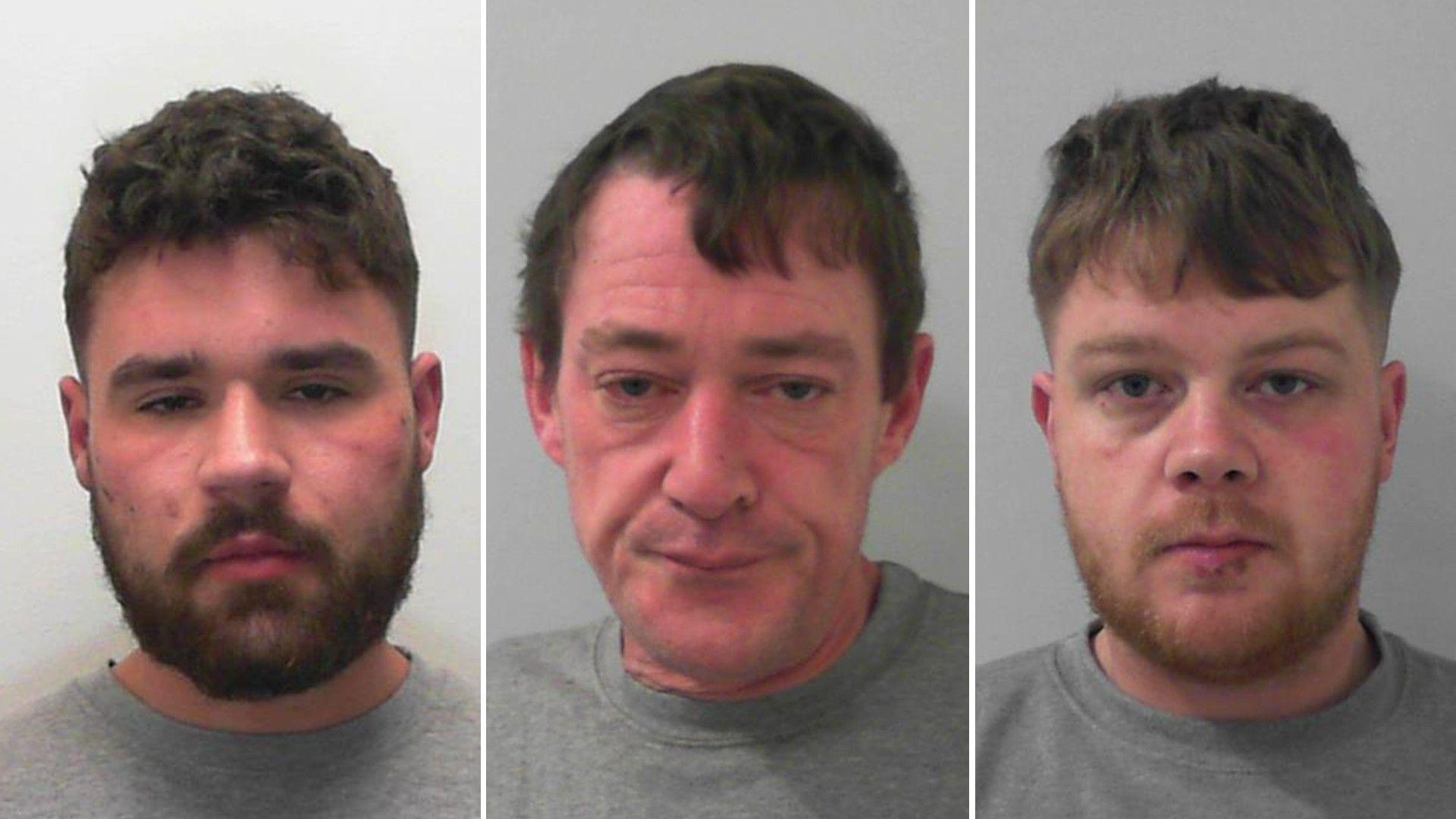 Side-by-side mugshots of three criminals, all of whom are wearing grey sweaters. The men at the sides are in their twenties with short beards and the man in the middle is aged around 50. He has short hair