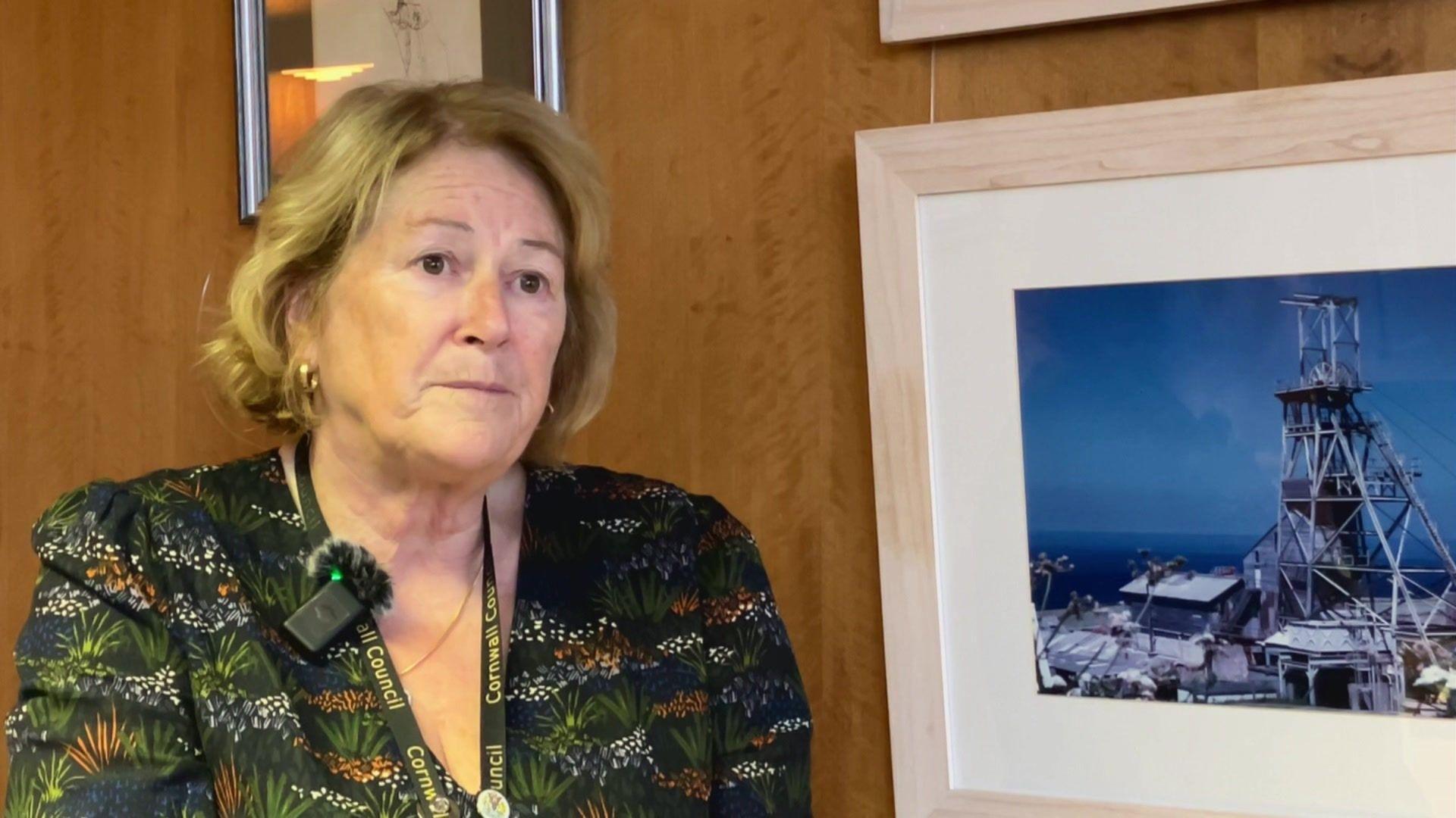 Woman in front of wall with pictures 