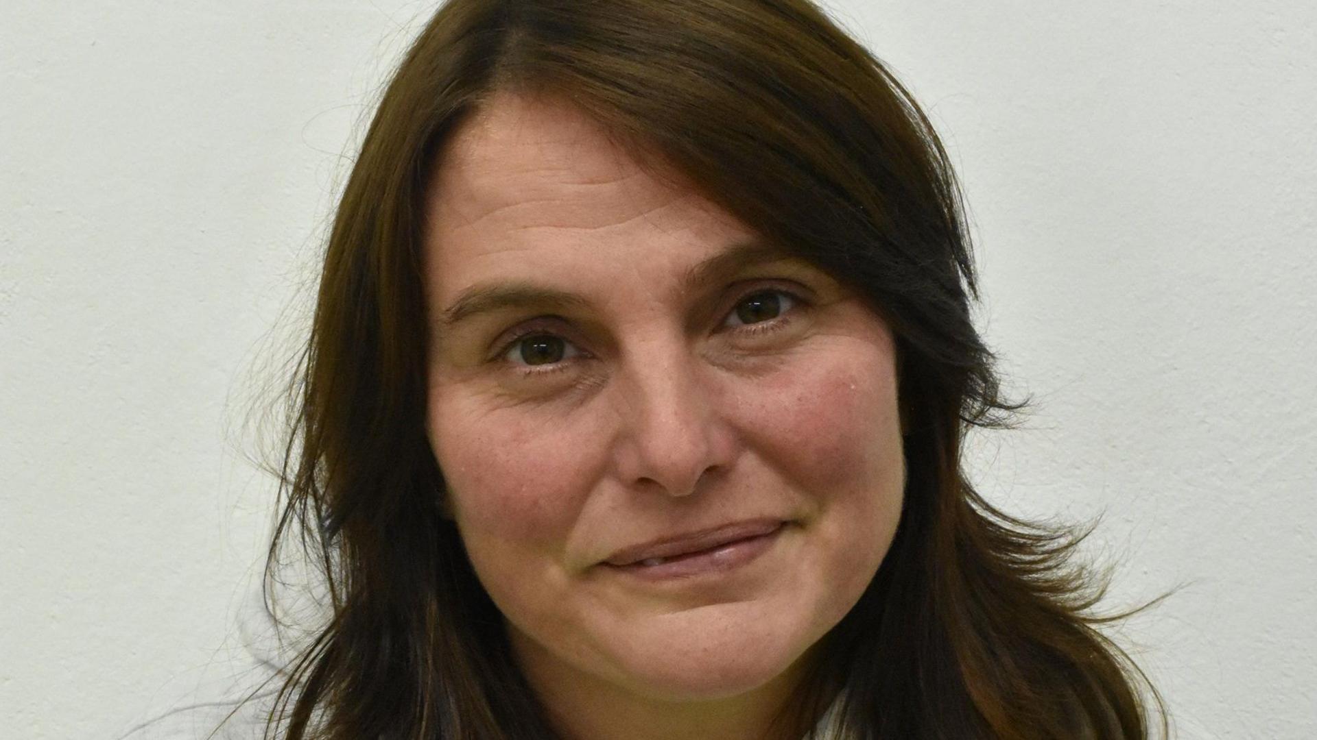 Profile photo of a woman with dark brown hair 