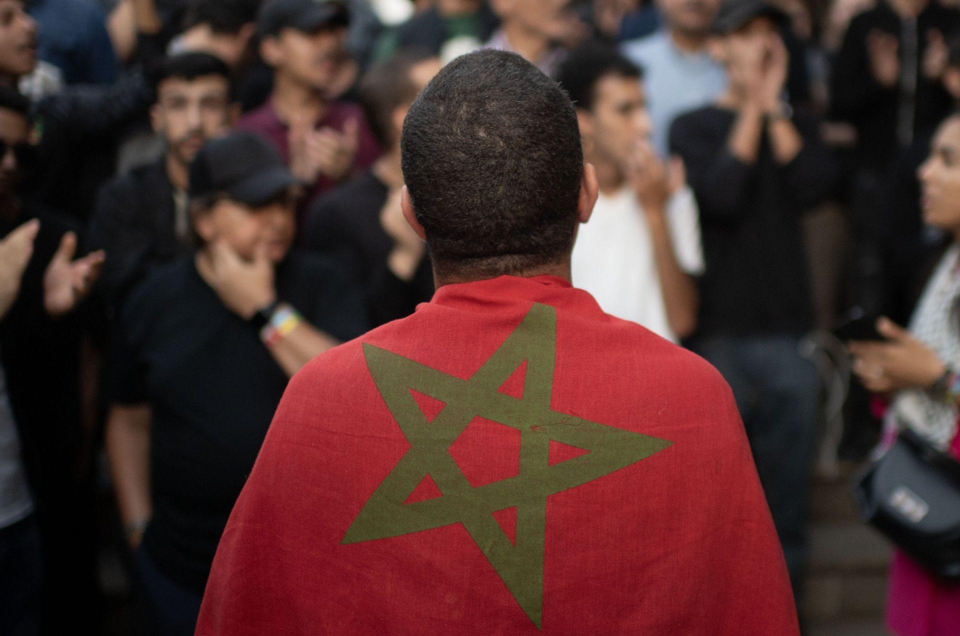 A man drapes the Moroccan flag over his back on 3 October.