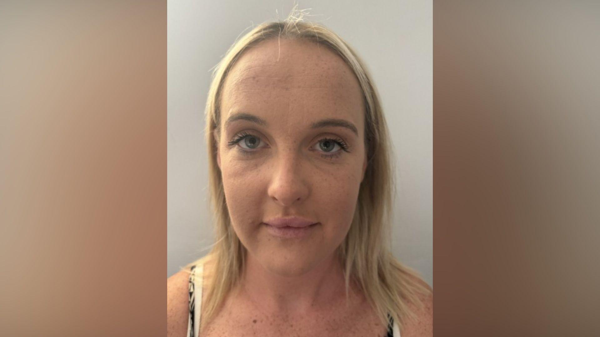 A police custody photo of Emily Drury - a young woman with blonde hair.