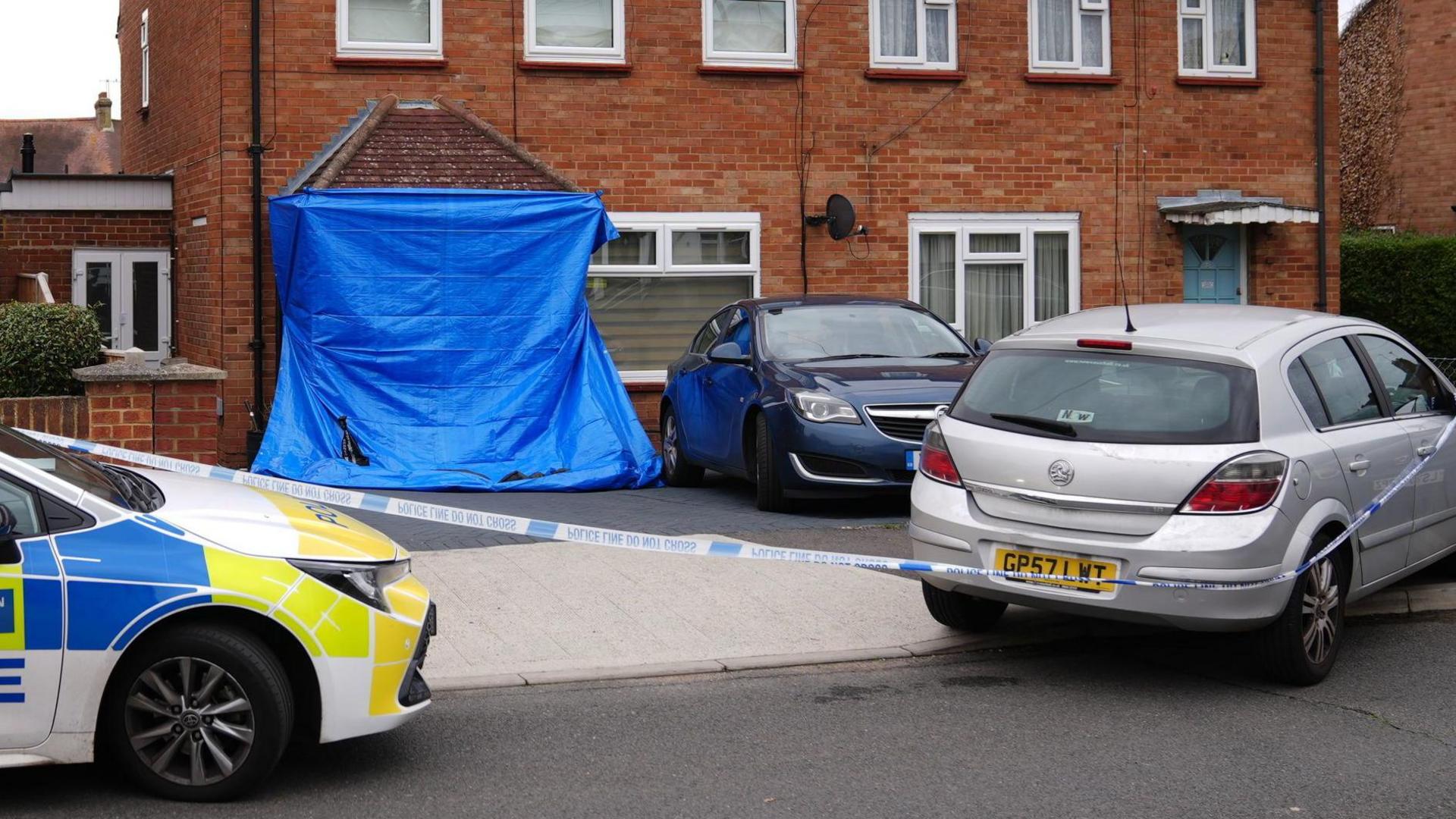 A blue tent outside a home in Midhurst Gardens in Uxbridge, west London.