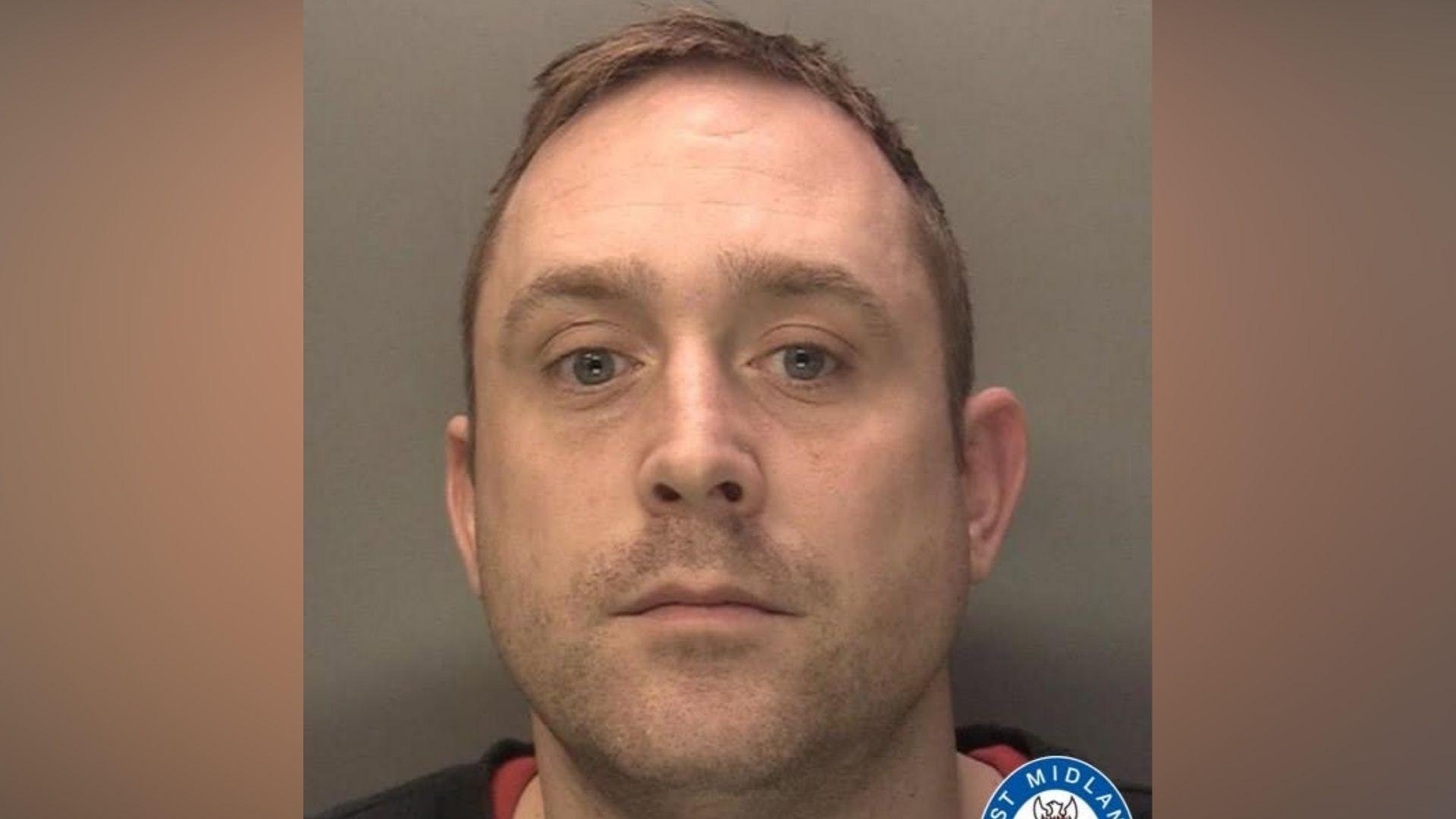 A custody image of Simon Tyler looking at the camera after being arrested.
