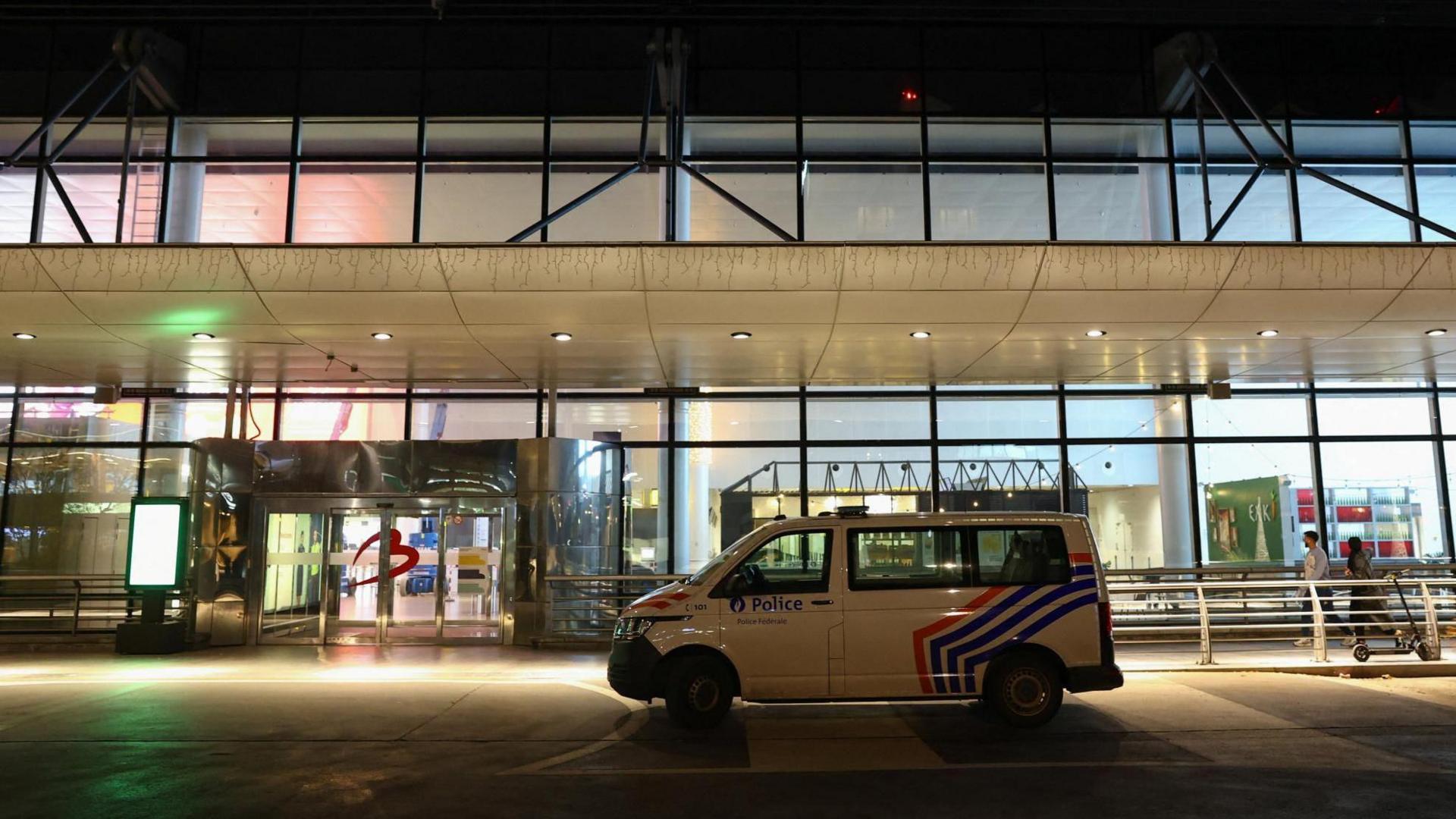 A police vehicle is parked outside the Brussels Airport