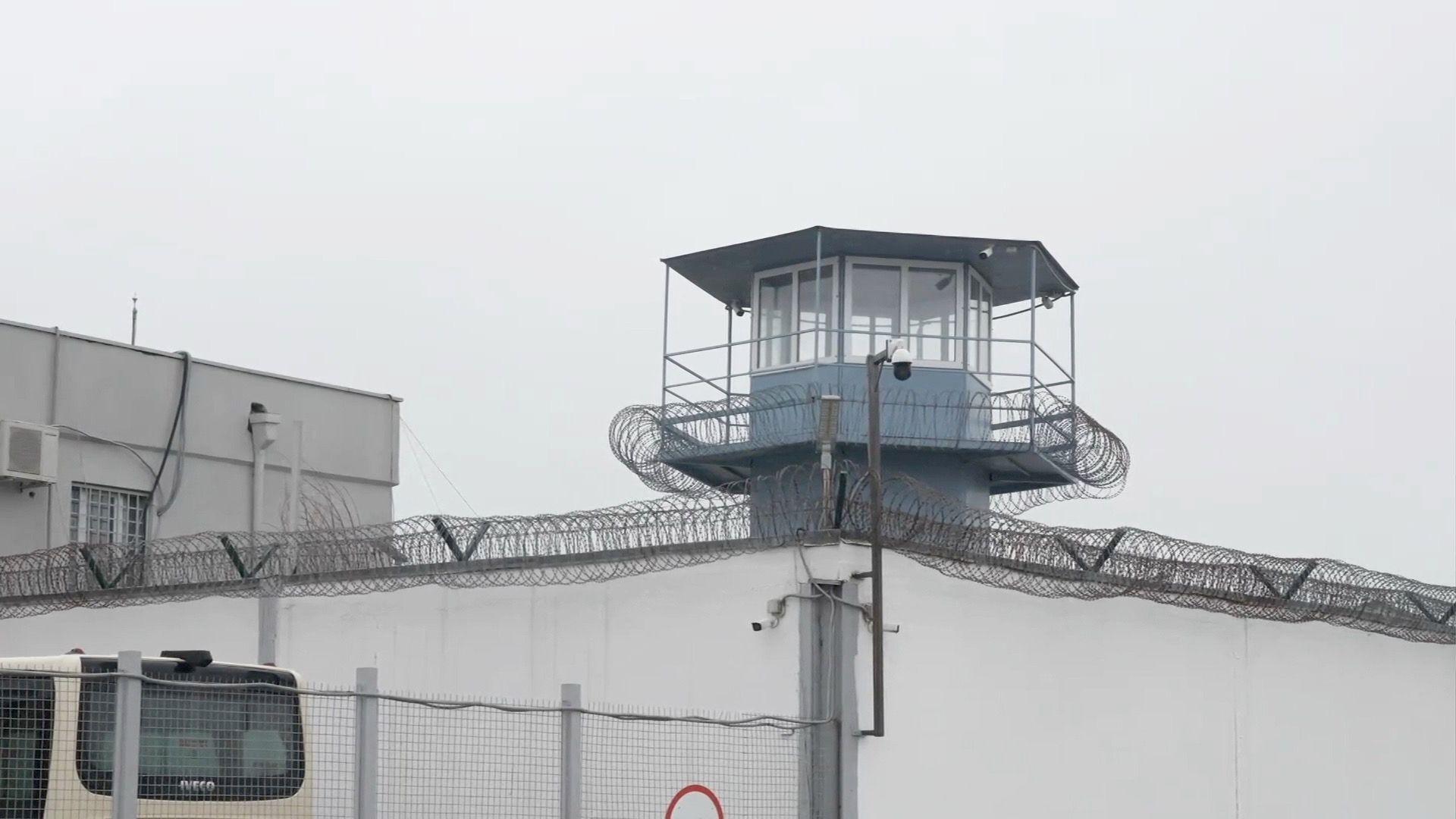Another look at the outside of the prison. The watchtower in the centre with barbed wire topped walls extending on either side.
