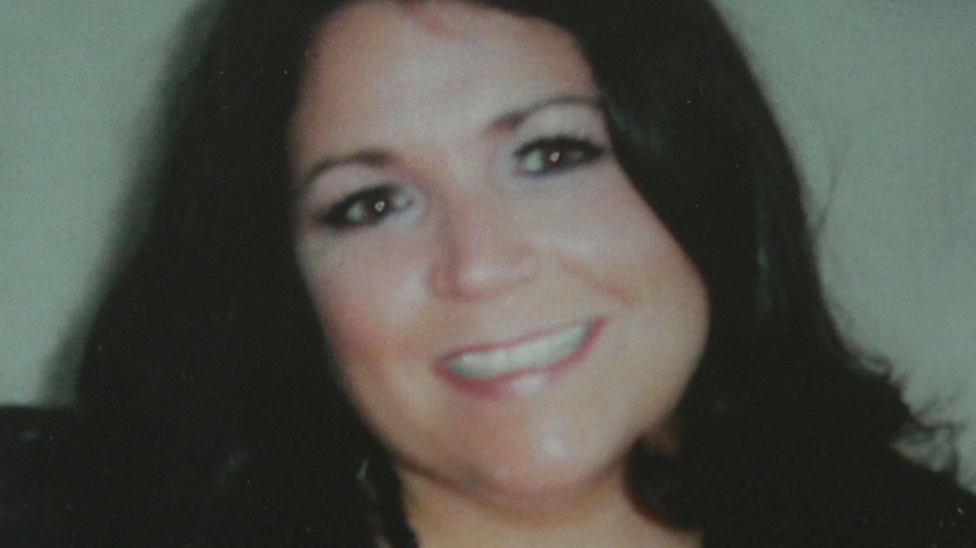 A close-up photograph of Zoe who has long dark hair and is smiling at the camera.