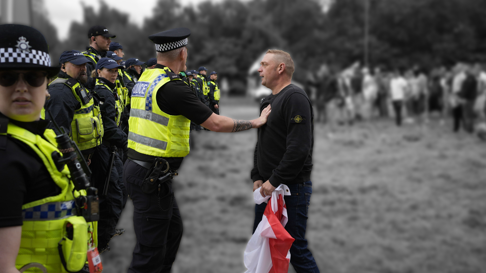 A man with a flag next to police