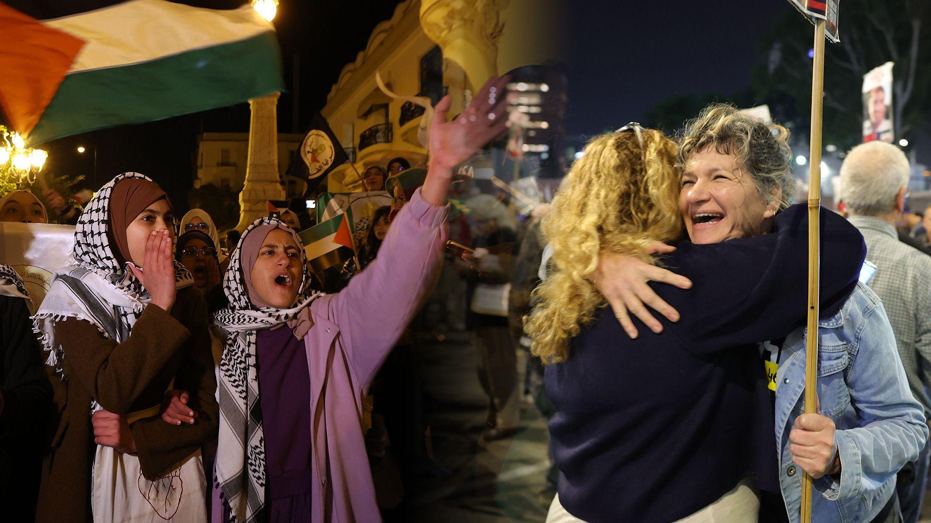 Two Palestinian women cheer underneath a Palestine flag, whilst two Israeli women hug each other