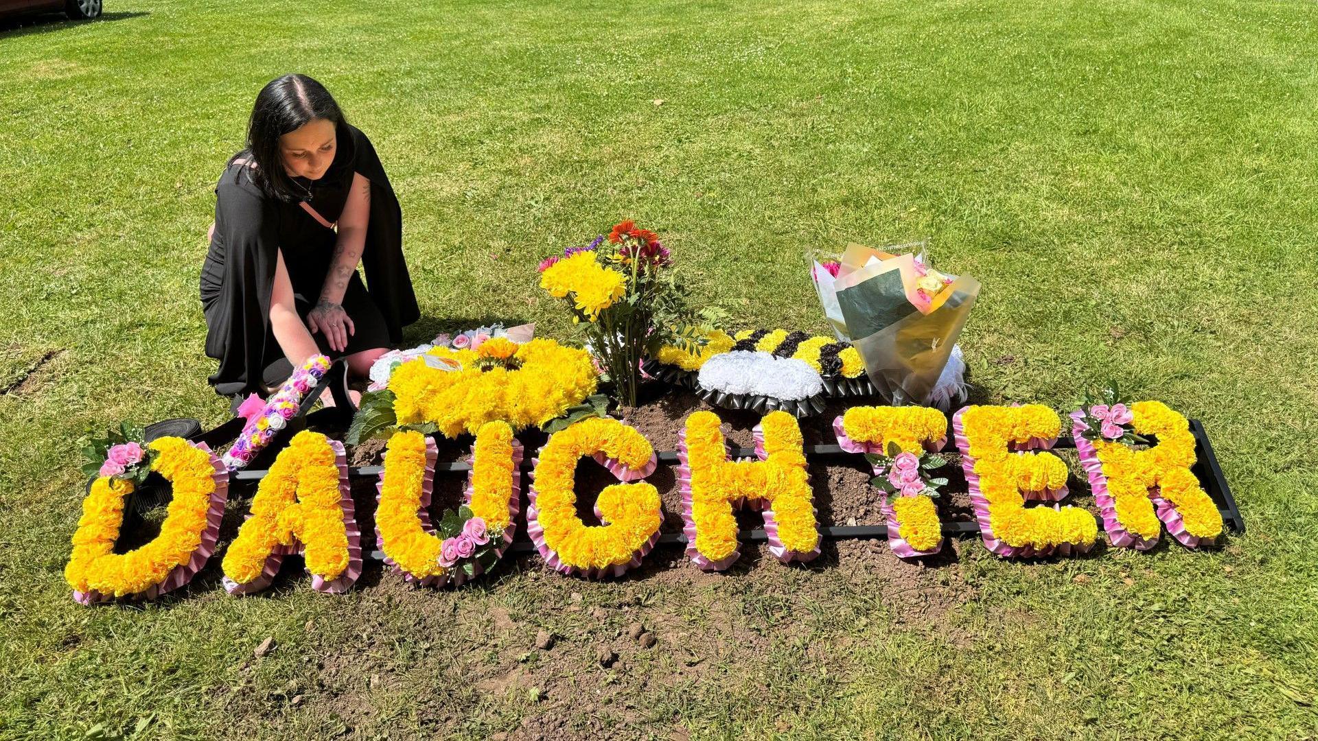 Scarlett next to her daughter's grave