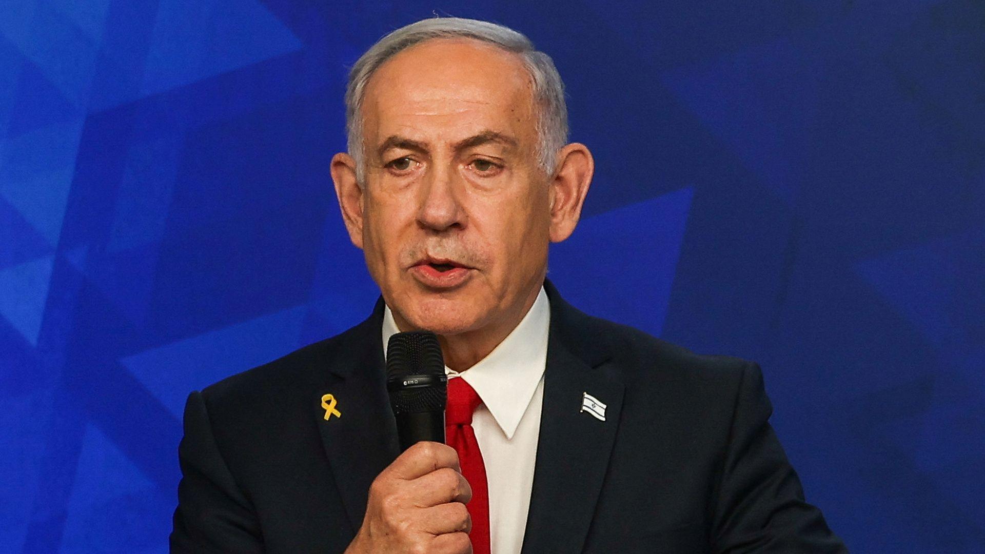 Israeli Prime Minister Benjamin Netanyahu speaks into a microphone in a suit and tie as he gives a press conference in Jerusalem on 21 May 2025.