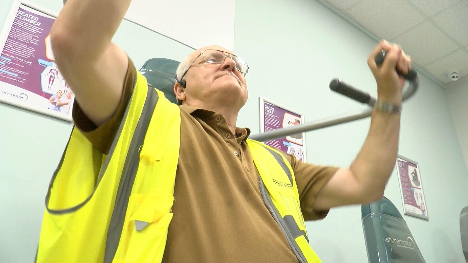 Nigel Timbrell, sat on exercise equipment training in a gym in Torquay
