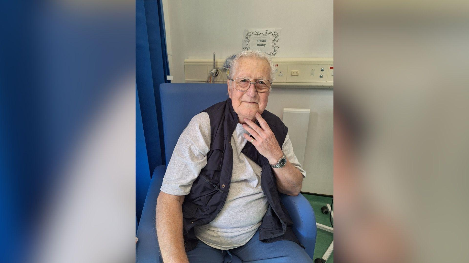 Terry Barraclough sitting in a hospital chair wearing a white T shirt and waistcoat
