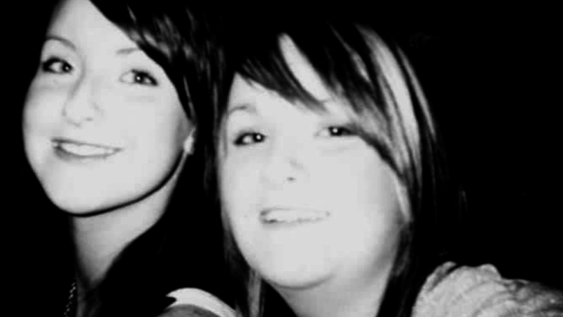 Natasha and her twin Nicola. A black and white photo, shows two sisters, similar looking with sweeping side fringes. Just their heads are visible 