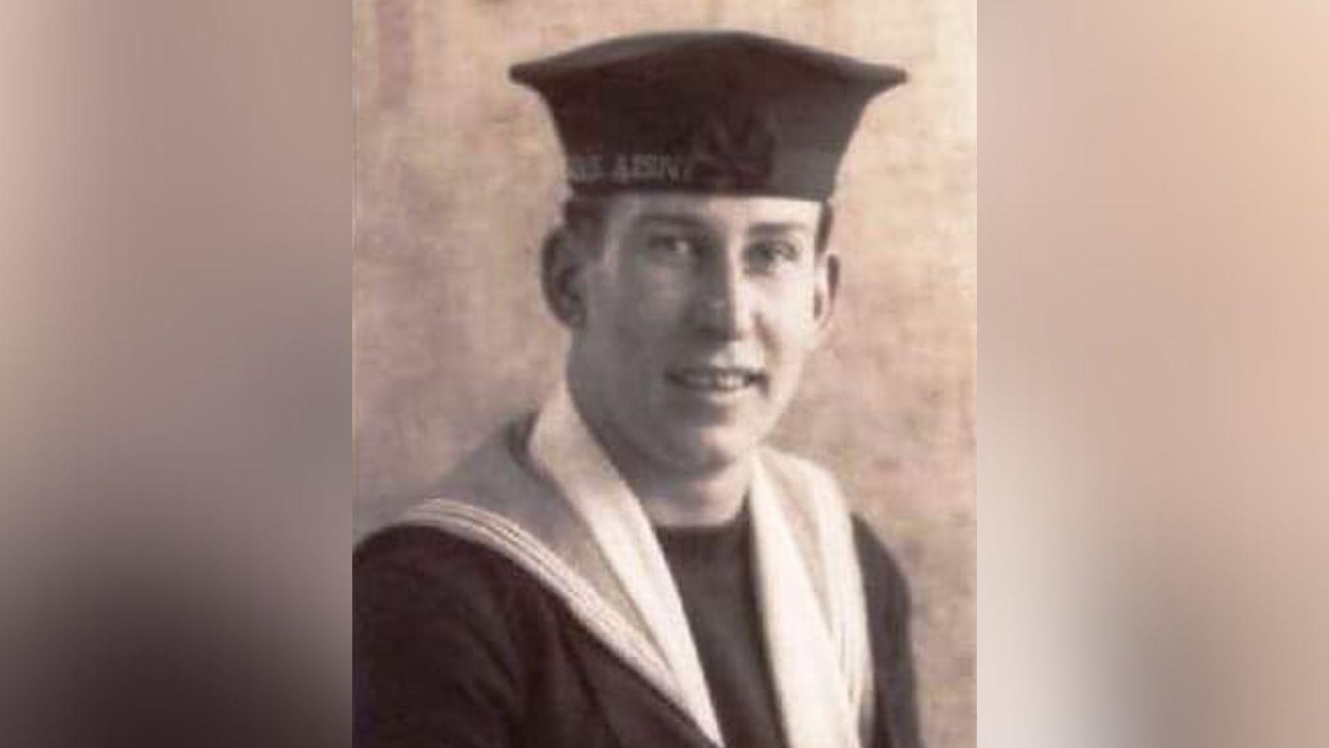 A young George Winter in a black and white headshot style image. He is wearing sailors uniform, including a hat.