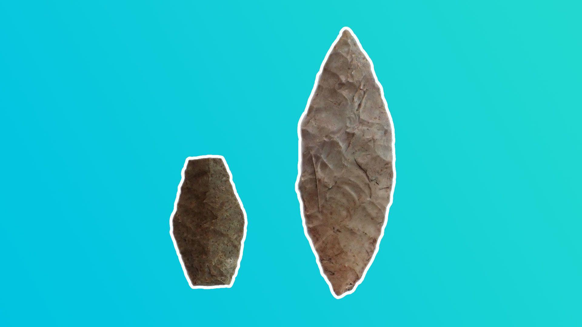 Two jagged pieces of stone, from a stone age burial site, on a blue coloured background