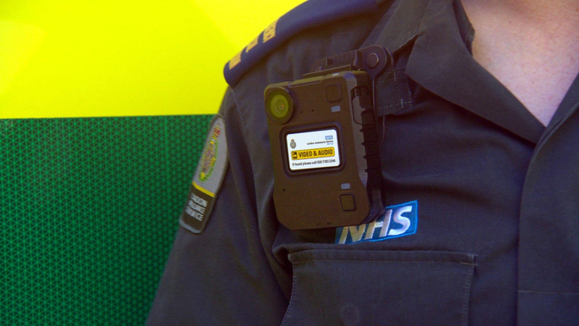 An NHS worker wearing a body camera.