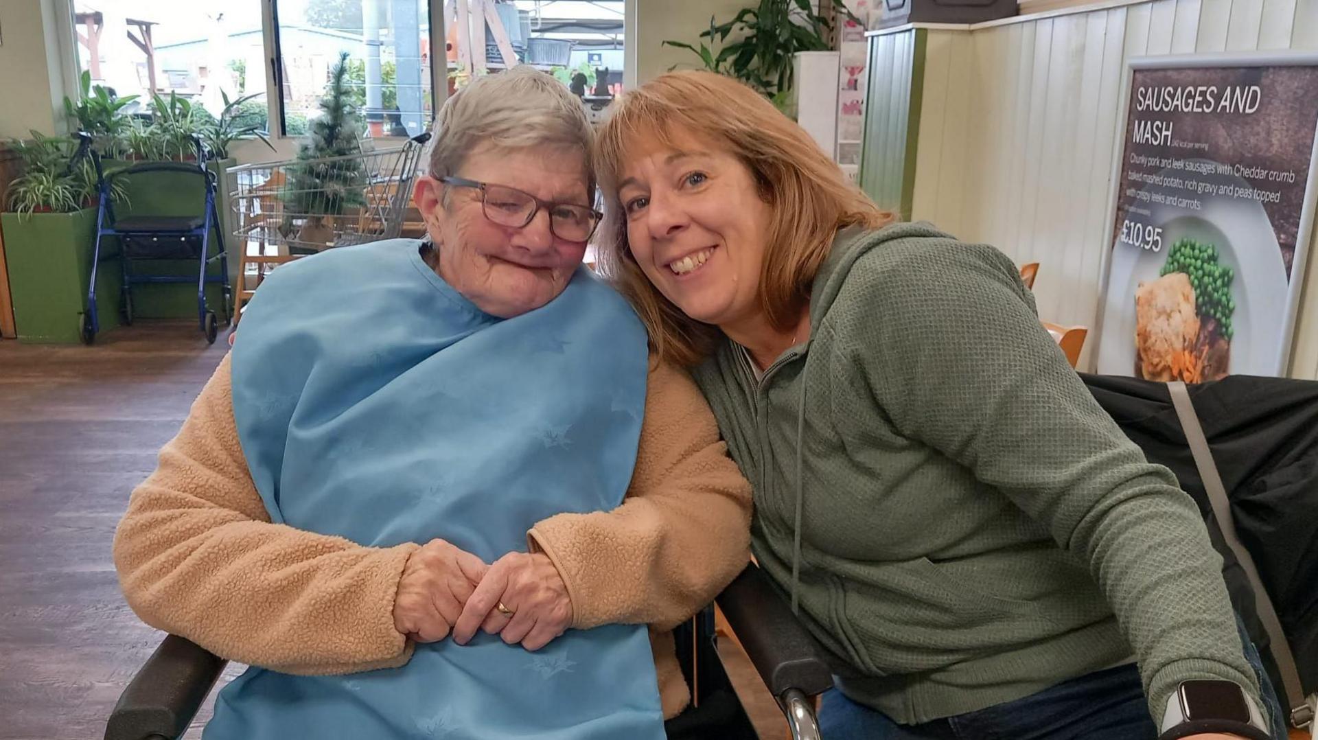 Janine and Kath Hercock both seated and smiling at the camera