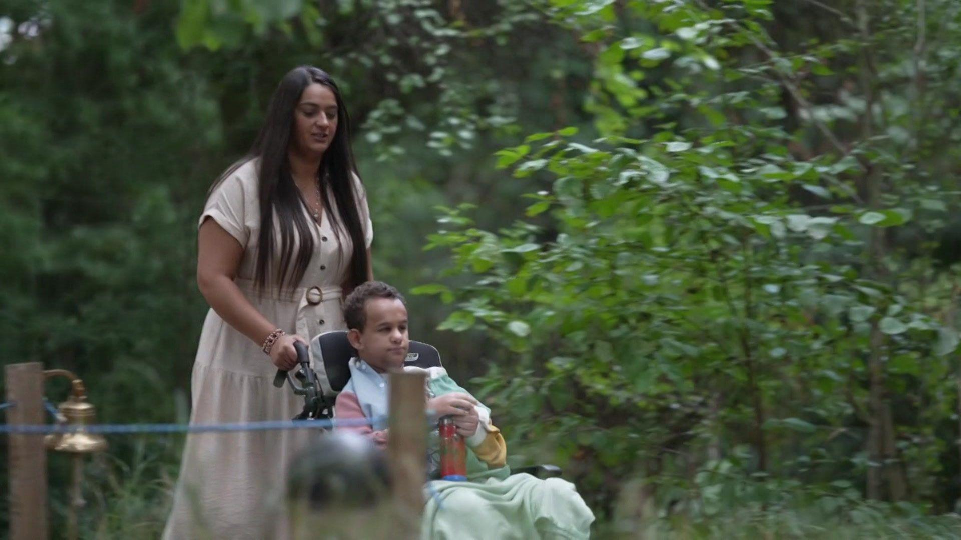 Mum Kareema and son Jayden in the garden with Jayden in a wheelchair