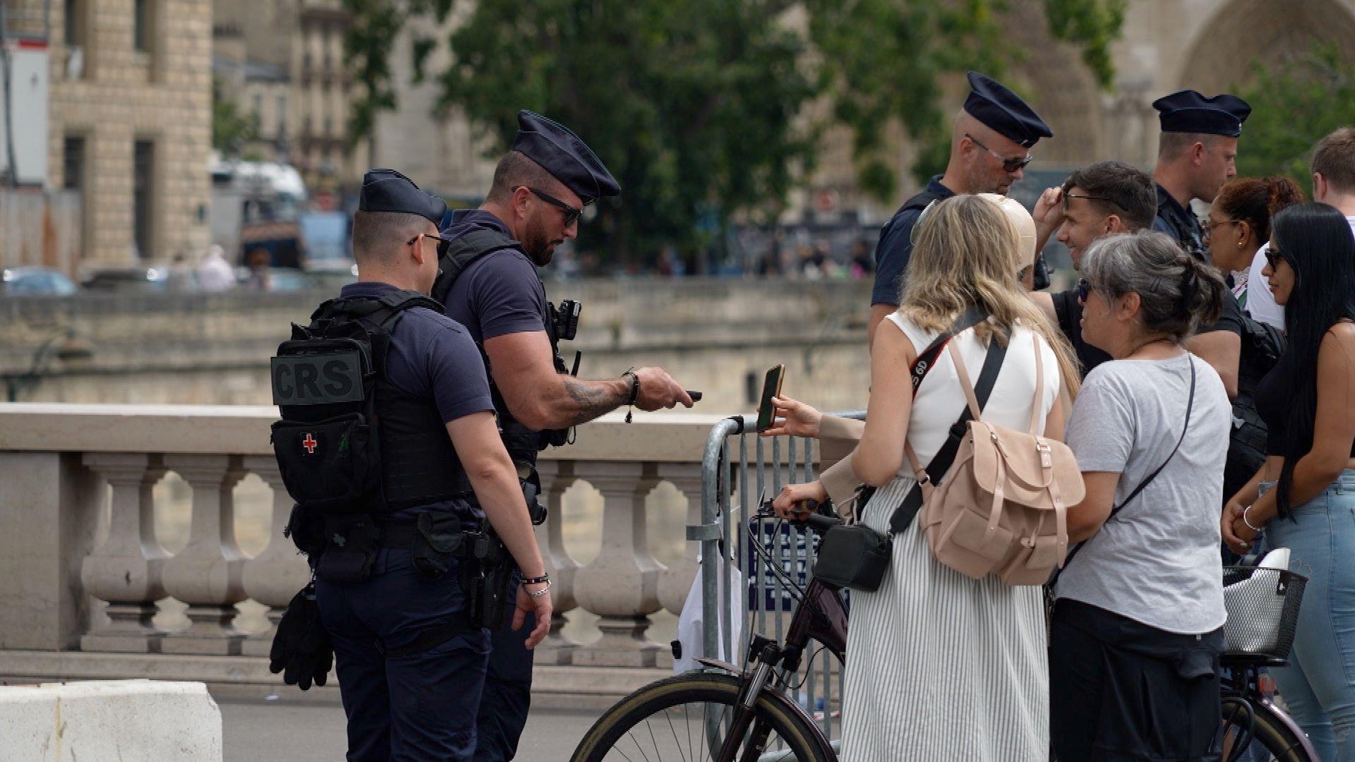 People queue to get through a checkpoint in Paris