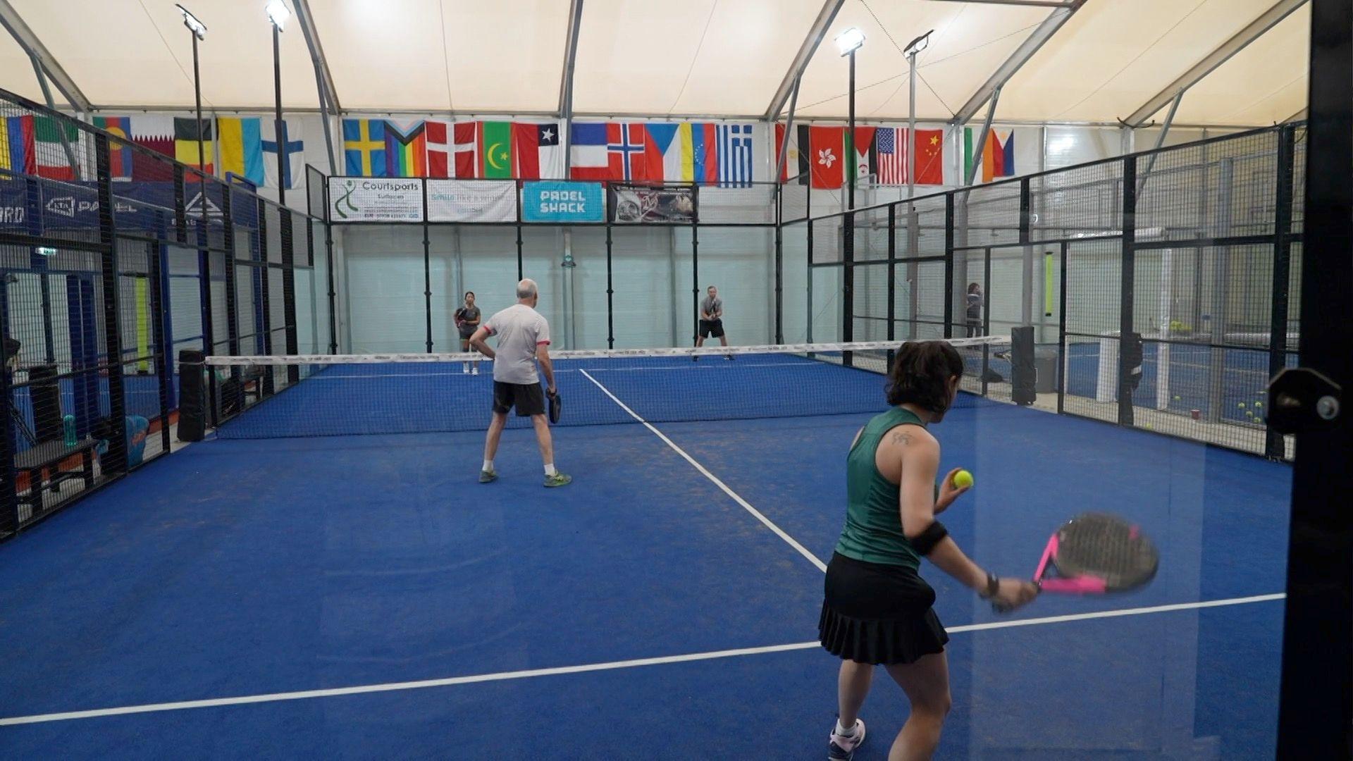 four people playing padel