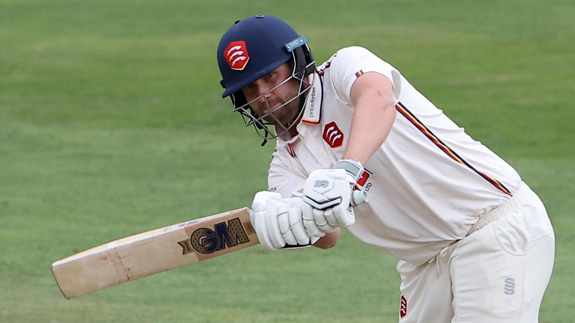Matt Critchley swings the bat in two hands during a match