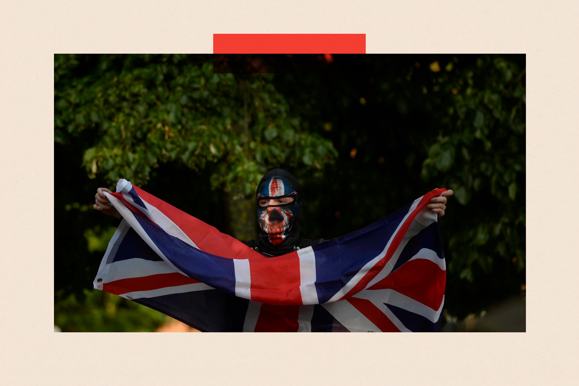 An individual waving an Union flag during anti-immigration protest in Belfast city centre