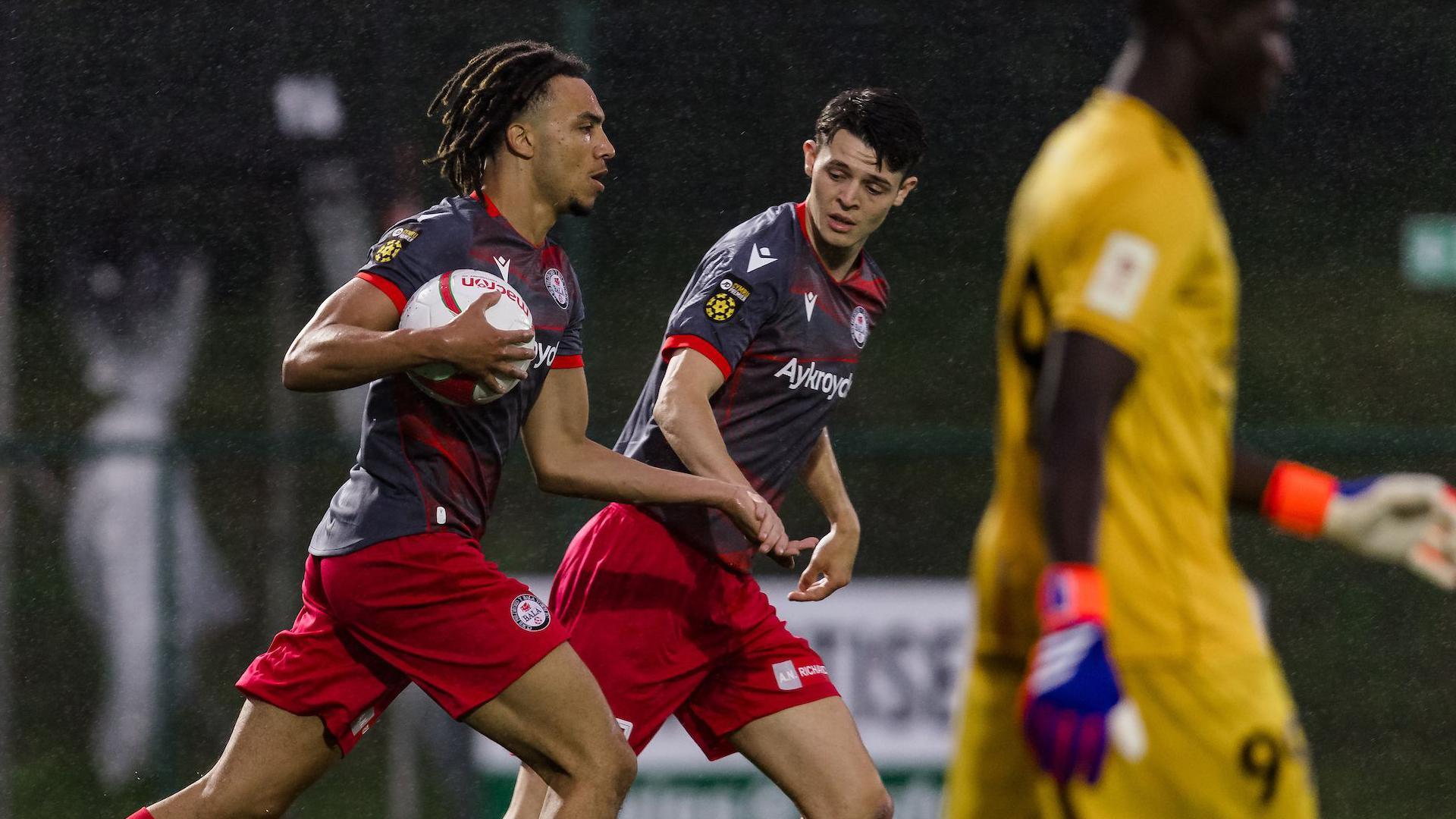 Josh Ukek carries the ball after scoring