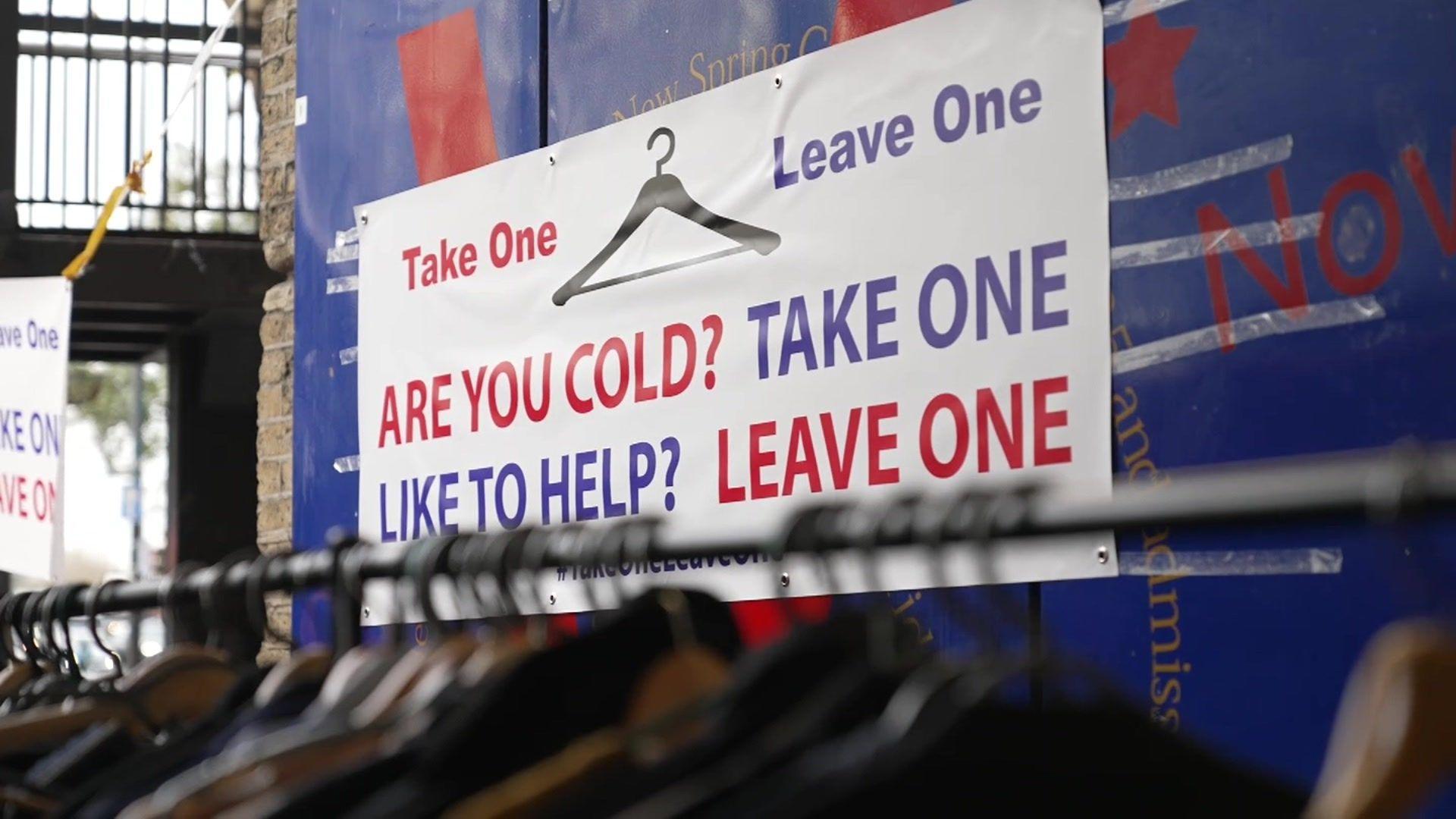 Take One Leave One banner above clothes rail