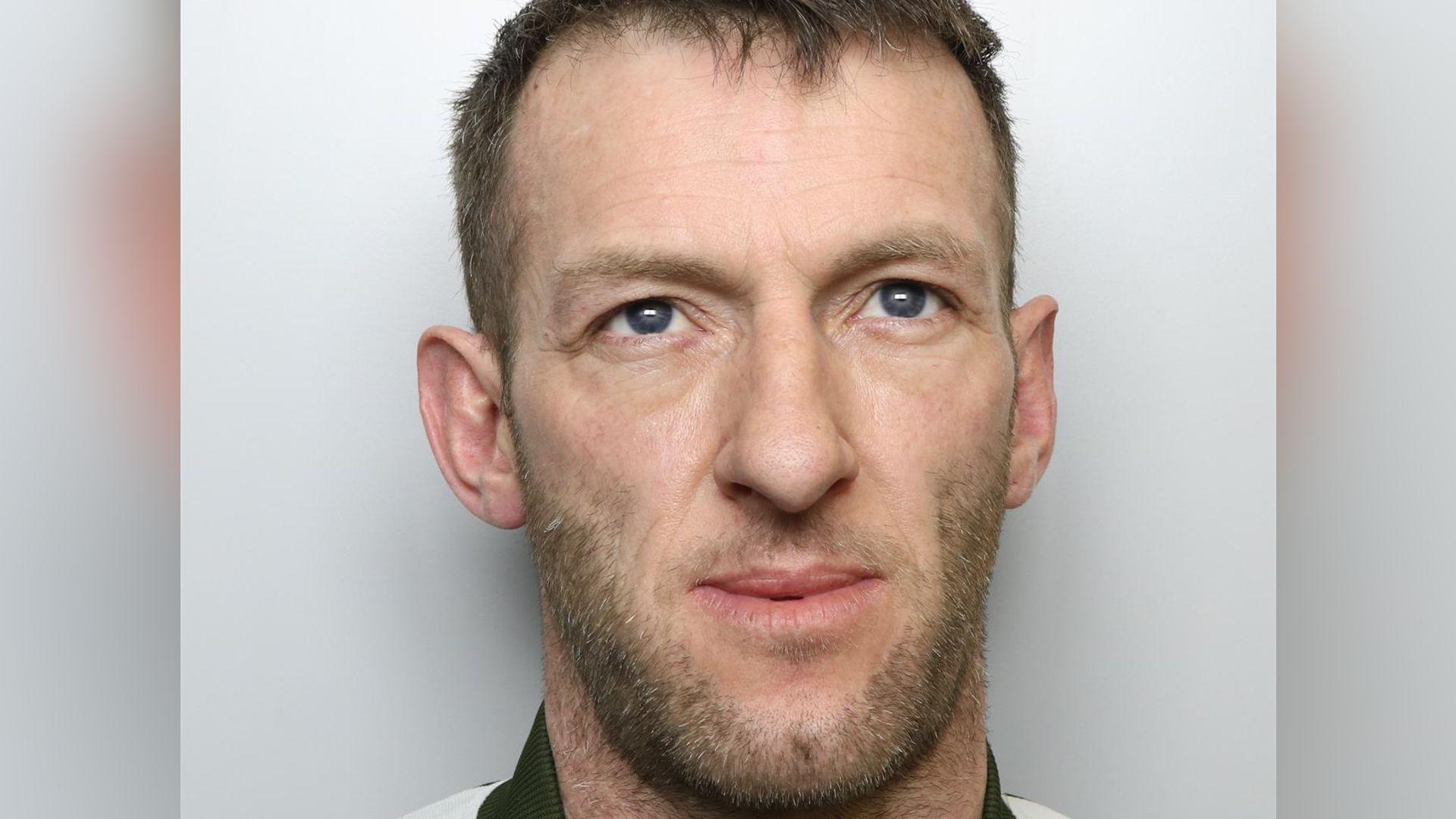 A mugshot of Craig Barker, who is 41. He has short brown hair, a short brown beard and is looking up rather than directly at the camera. 