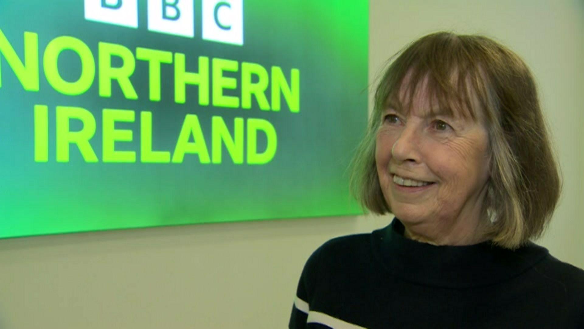 Anna Carragher in front of a green BBC Northern Ireland sign