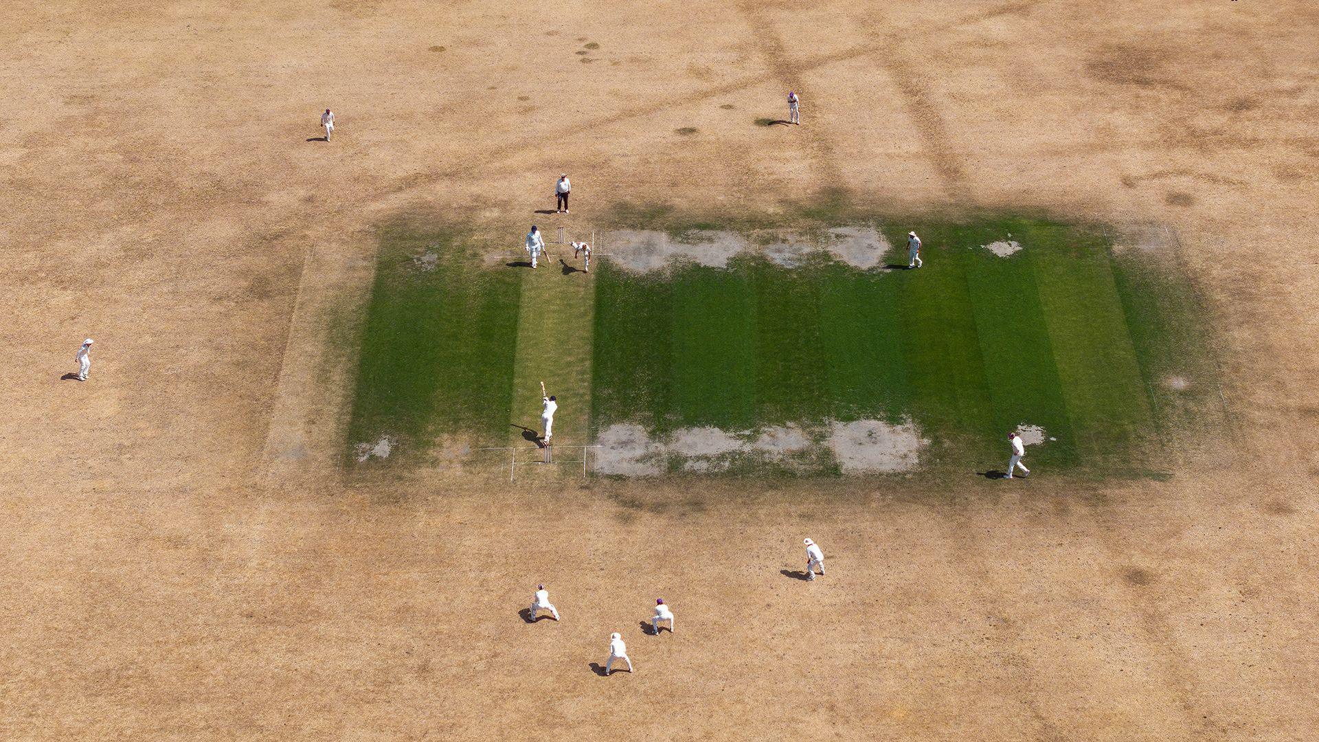 Cricketers play on parched ground in Bray