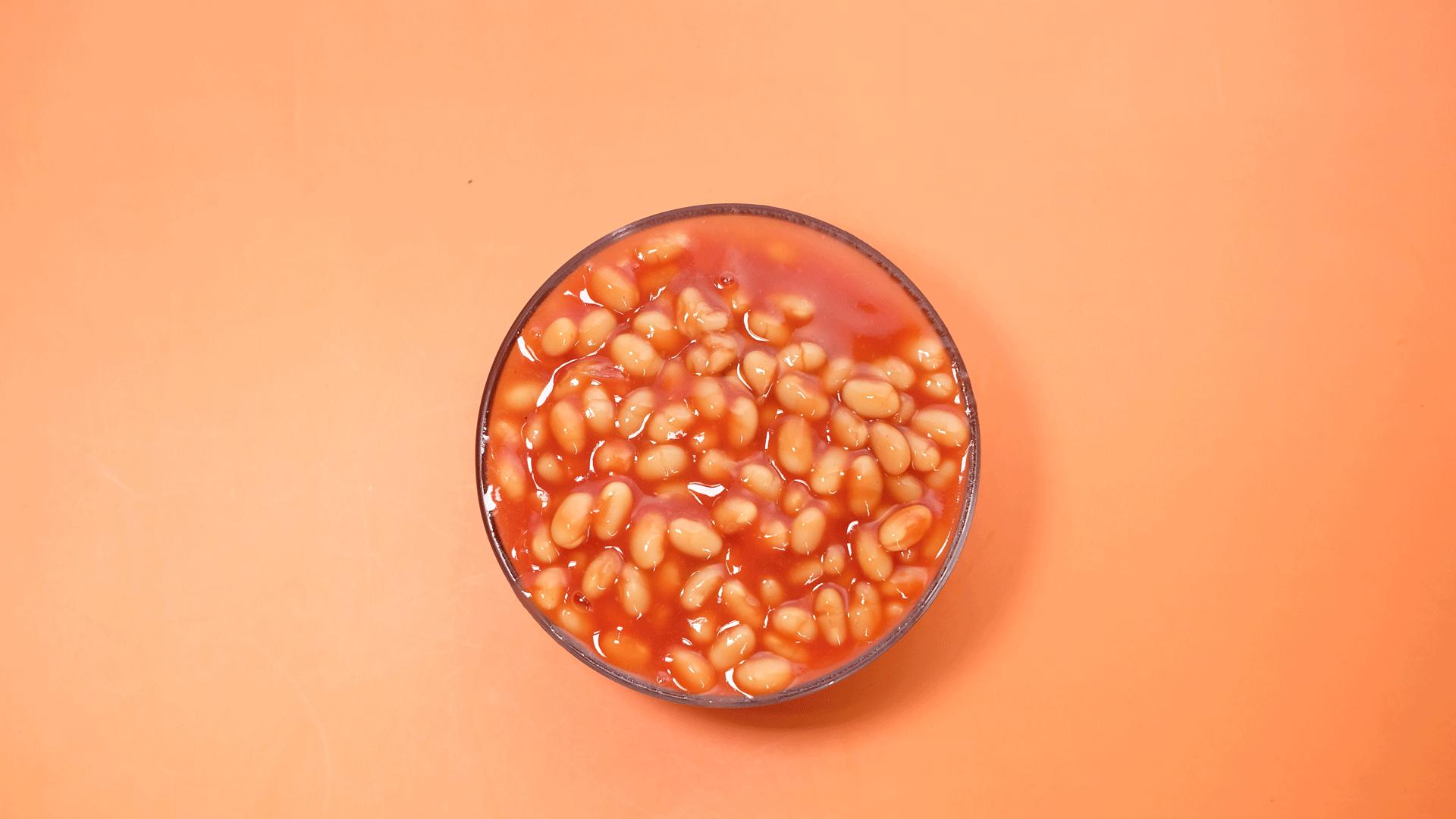 Glass bowl of baked beans from above