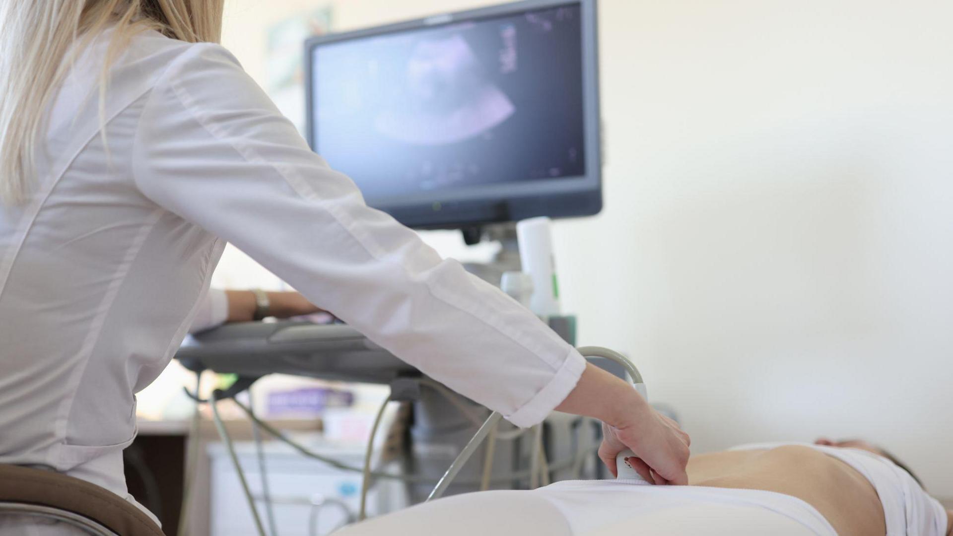 Medical professional performing a pregnancy scan