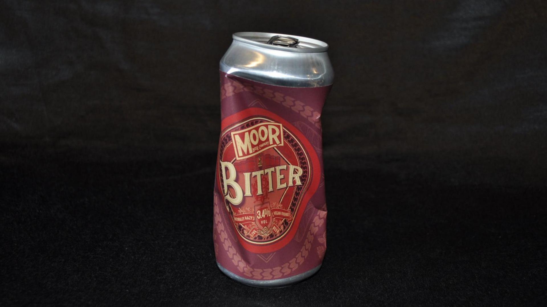 A picture of a can of bitter that has been drunk and the can crumpled slightly.