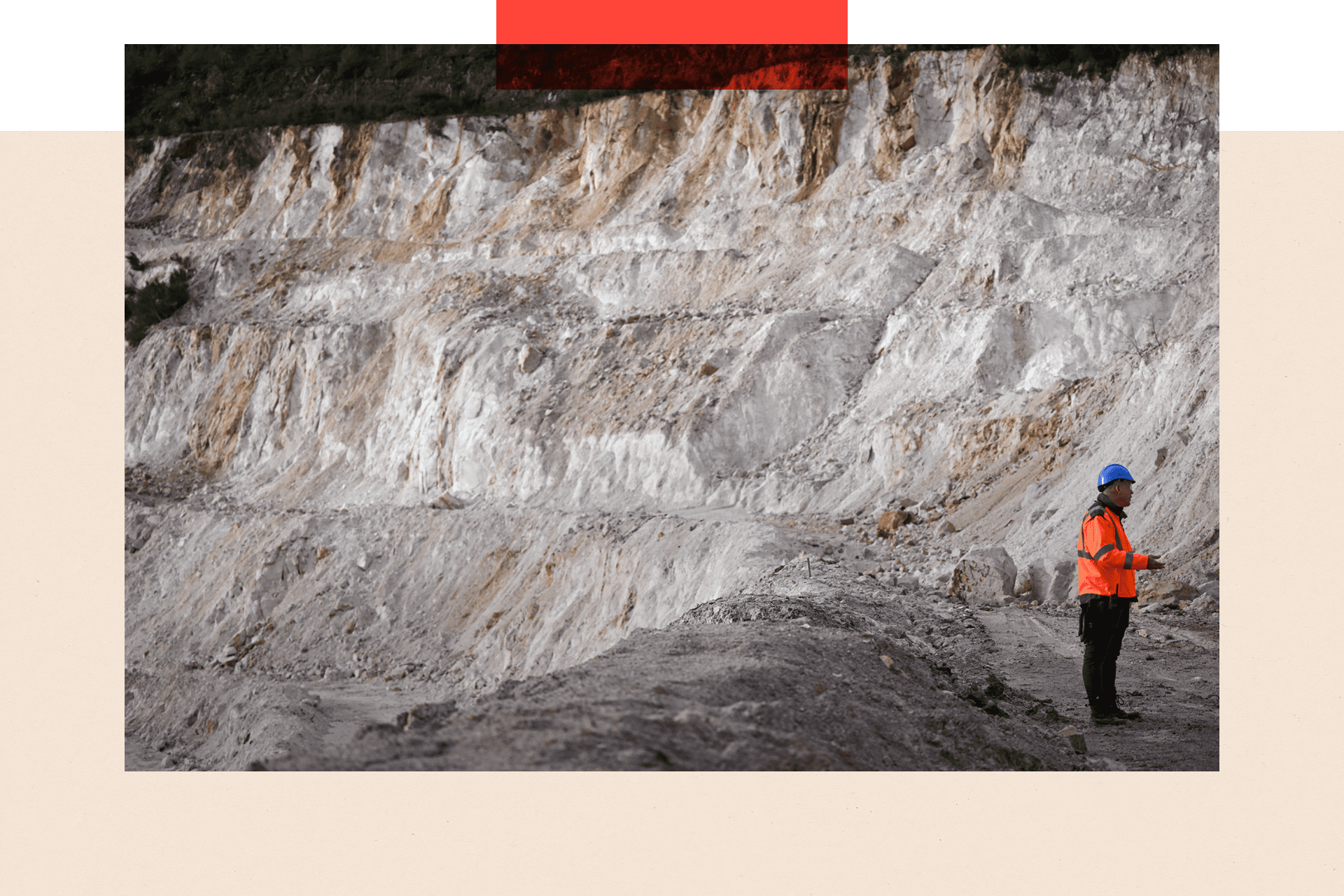 An employee walking in the open-pit mine at a lithium plant 