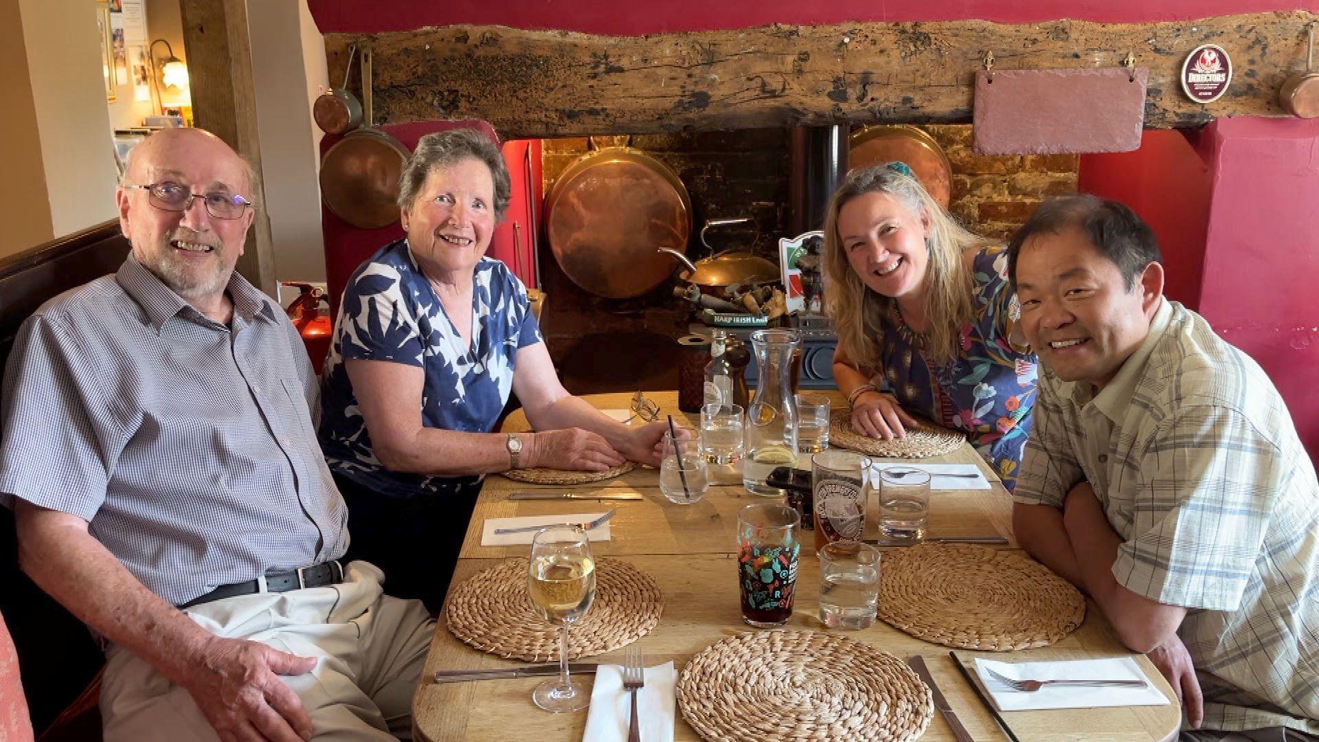 The Pritchard family sit at a pub table
