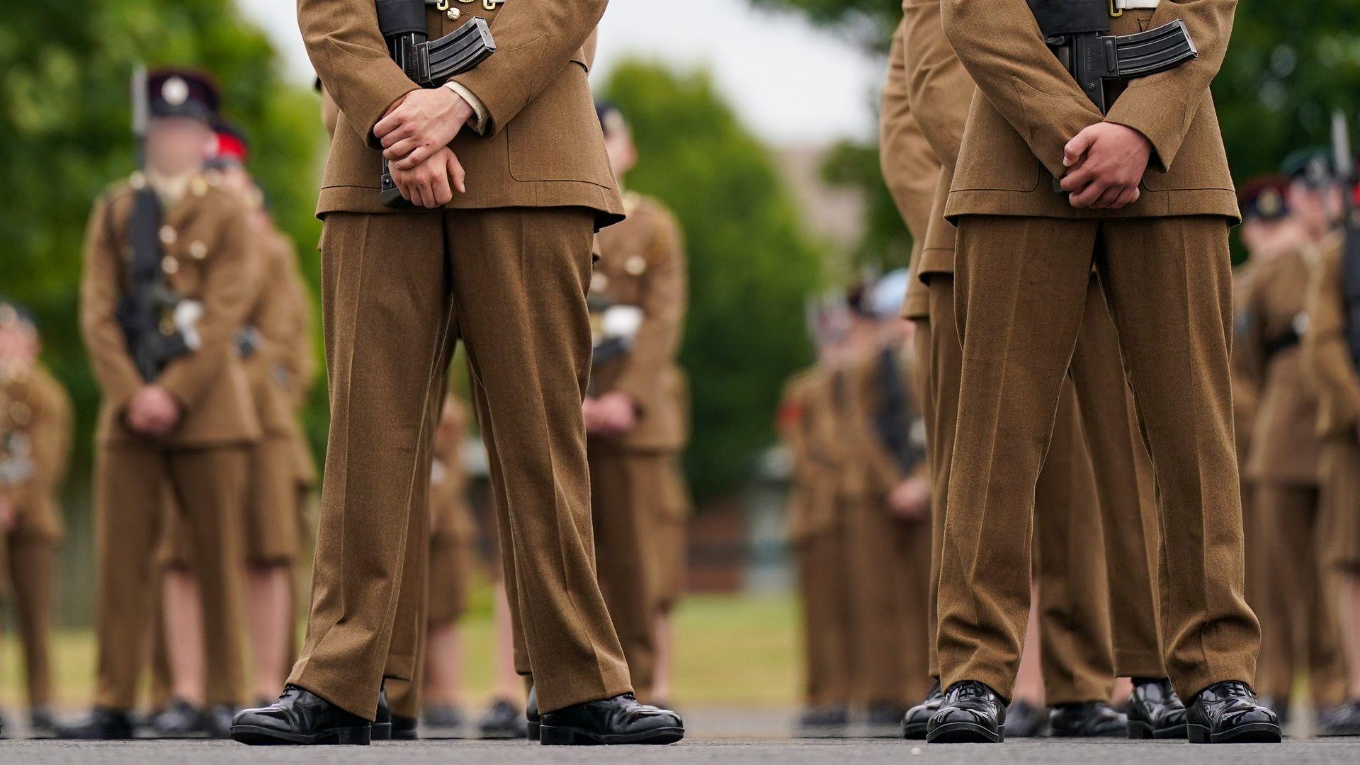 Junior soldiers wearing full military clothing stand to attention at the Army Foundation College for their graduation parade on 2024.