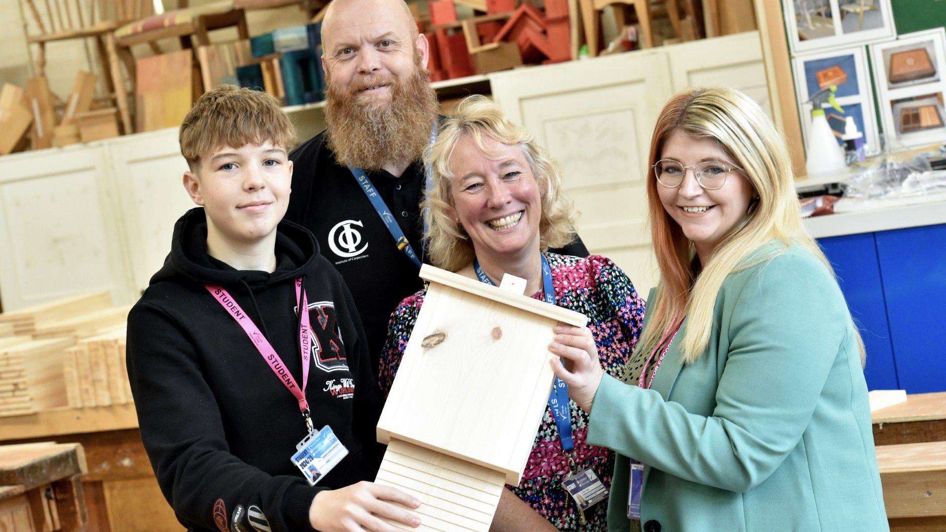 Students and staff from Newark College pose with a bat box.