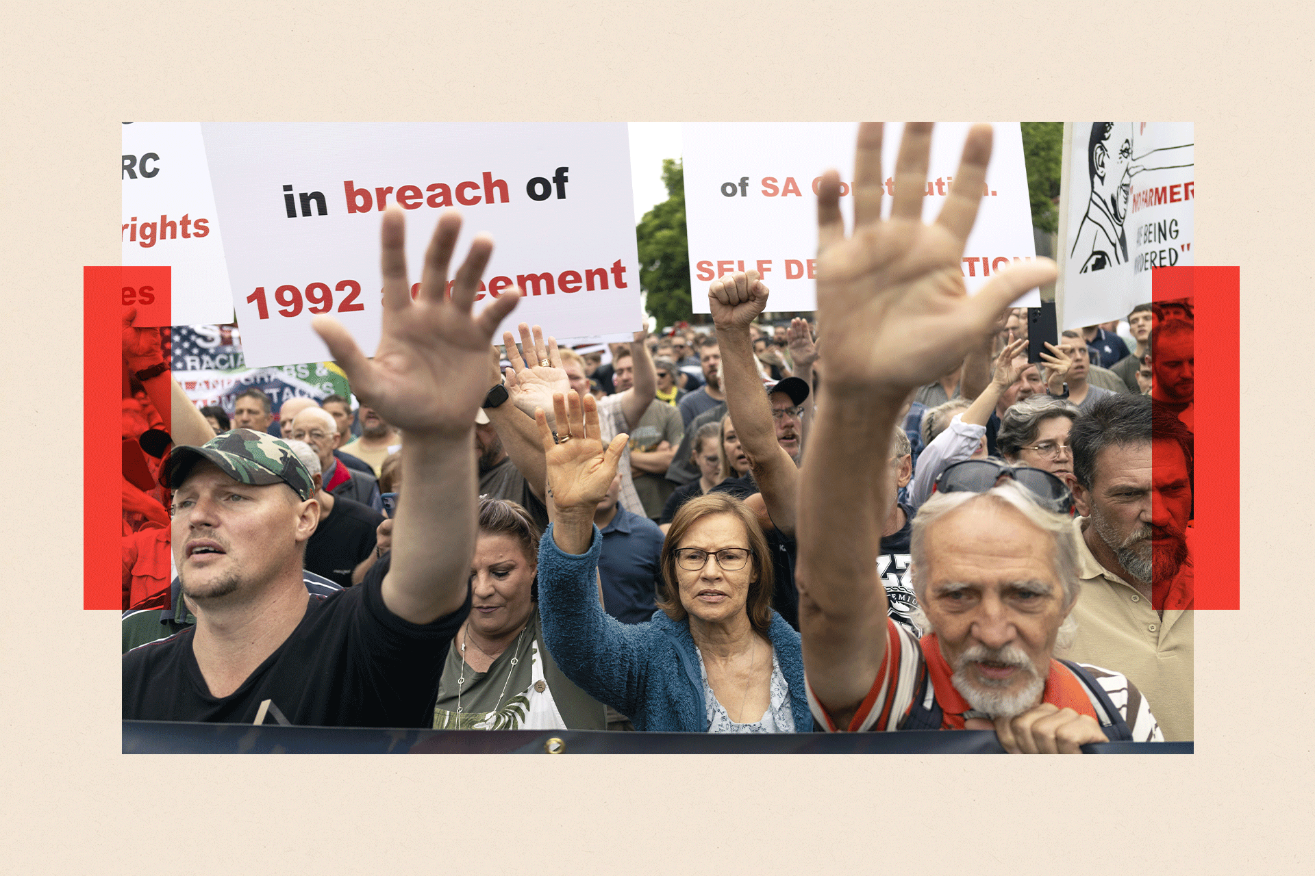 Afrikaaner farmers in South Africa rally with their hands in the air