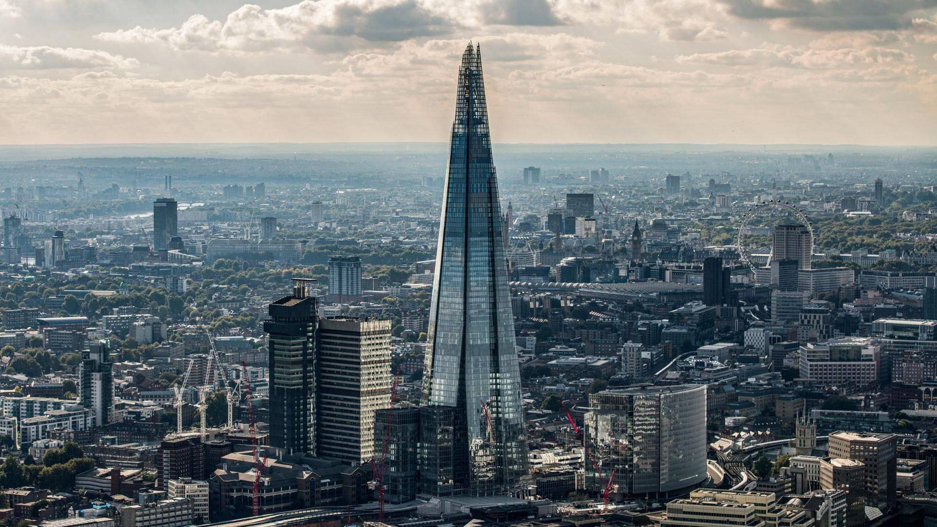 Image of The Shard towering over the City of London.