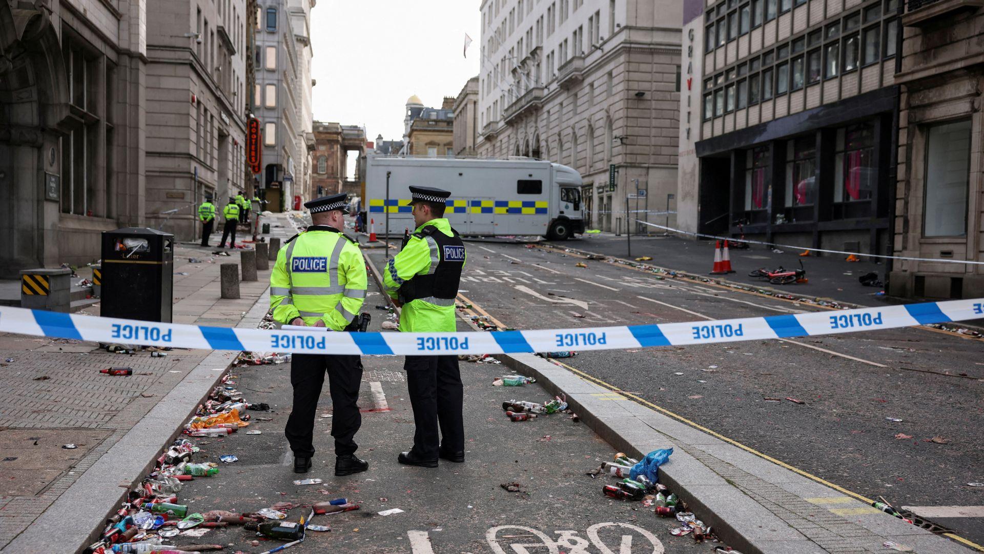 Forensic officers work near the site of an incident.