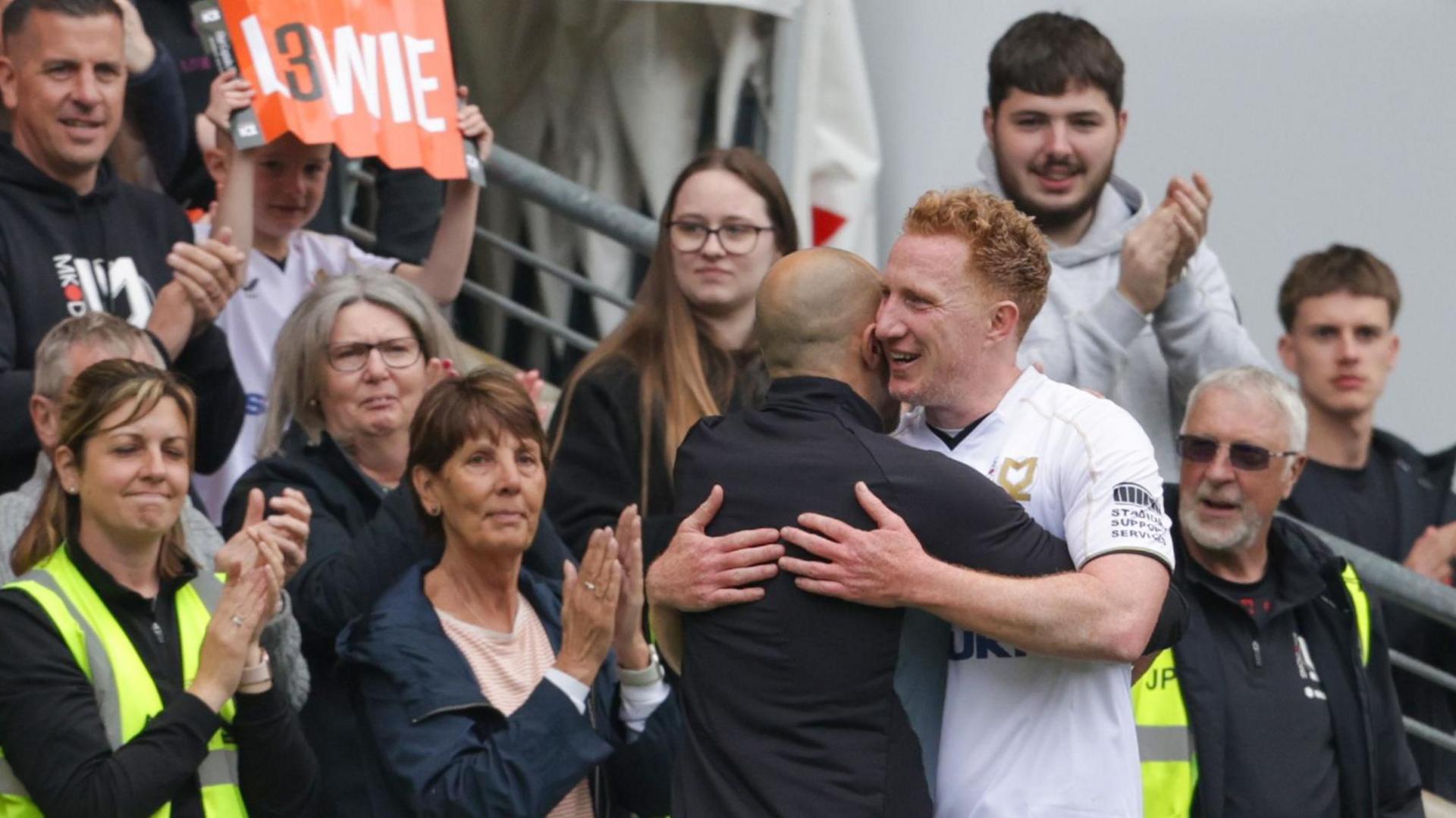 MK Dons supporters applaud Dean Lewington as he leaves the pitch during the game against Grimsby in April.