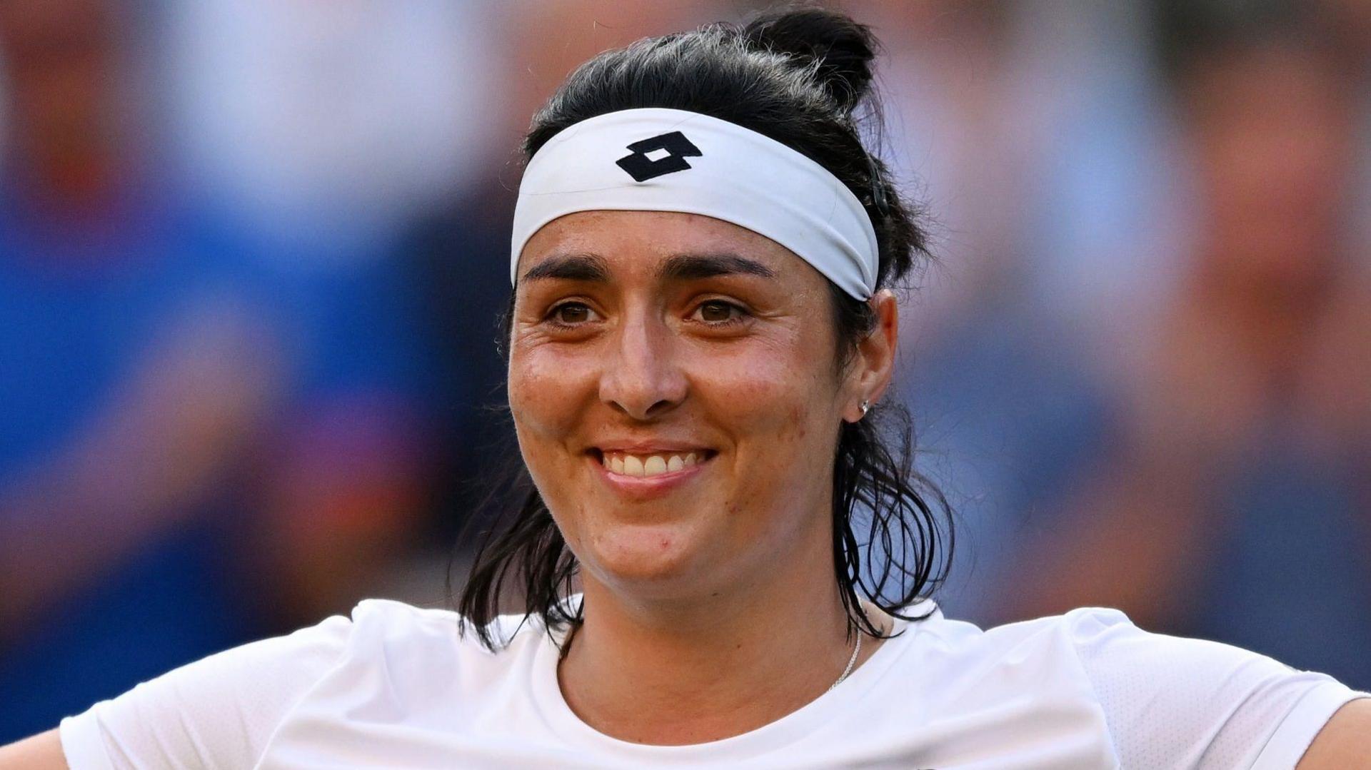 Ons Jabeur celebrates while competing at Wimbledon