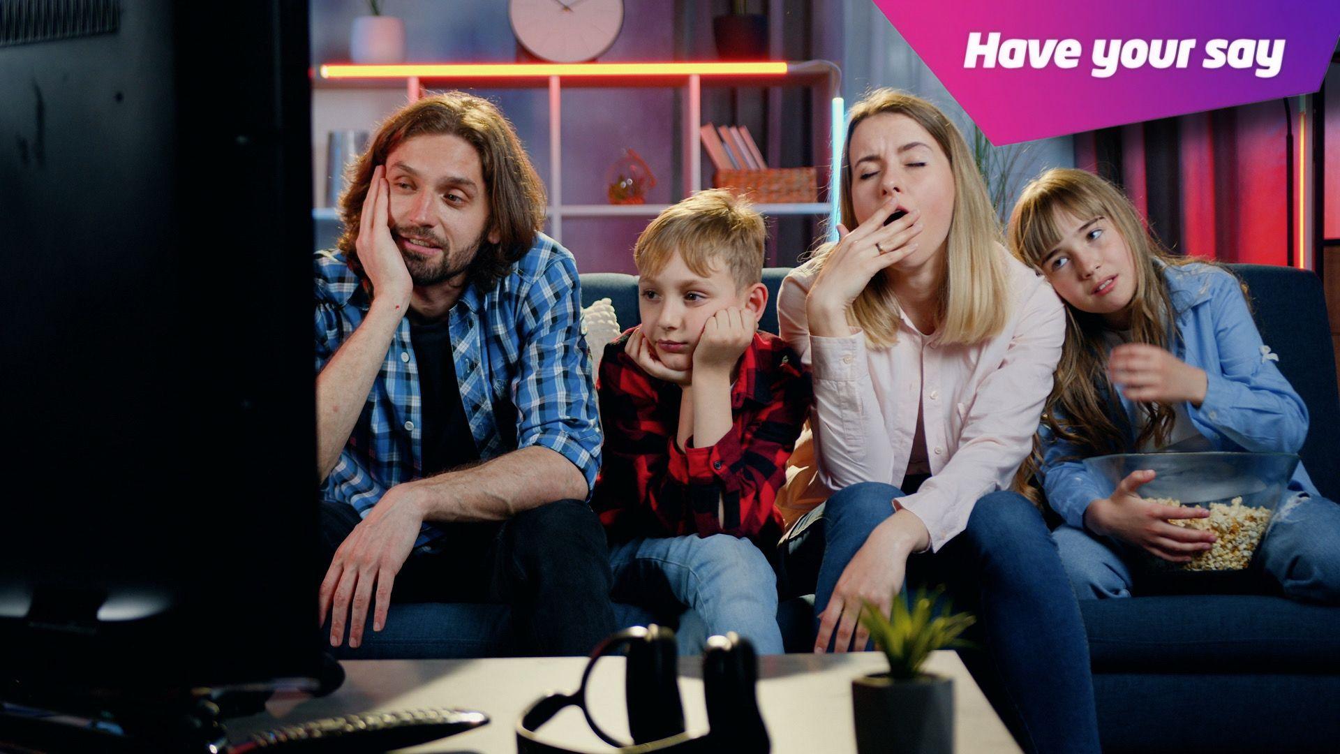 A tired family yawn and look sleepy in front of the TV.