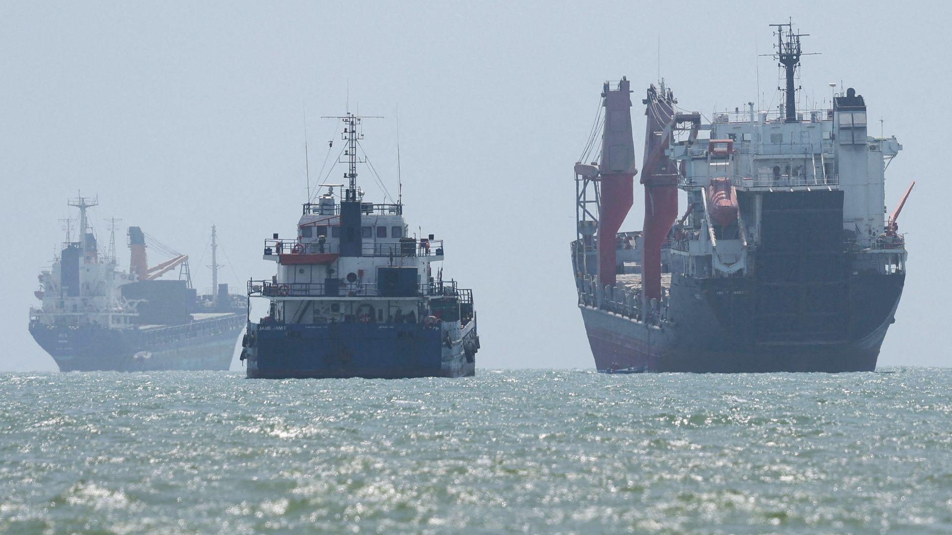 Vessels in the Strait of Hormuz are visible near the beach of Bandar Abbas, Iran, August 25, 2026