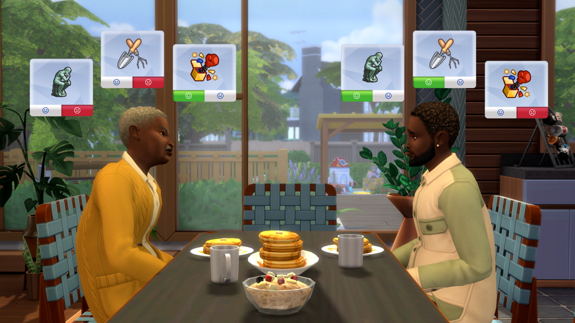 A Sims 4 screenshot shows two male characters with darker skin tones facing each other across a breakfast table. A garden can be seen through the plate glass sliding door behind them. Above each man's head are three icons in square boxes. Each appears to represent an activity or emotion and a green happy face/red sad face denoting their reaction to it.